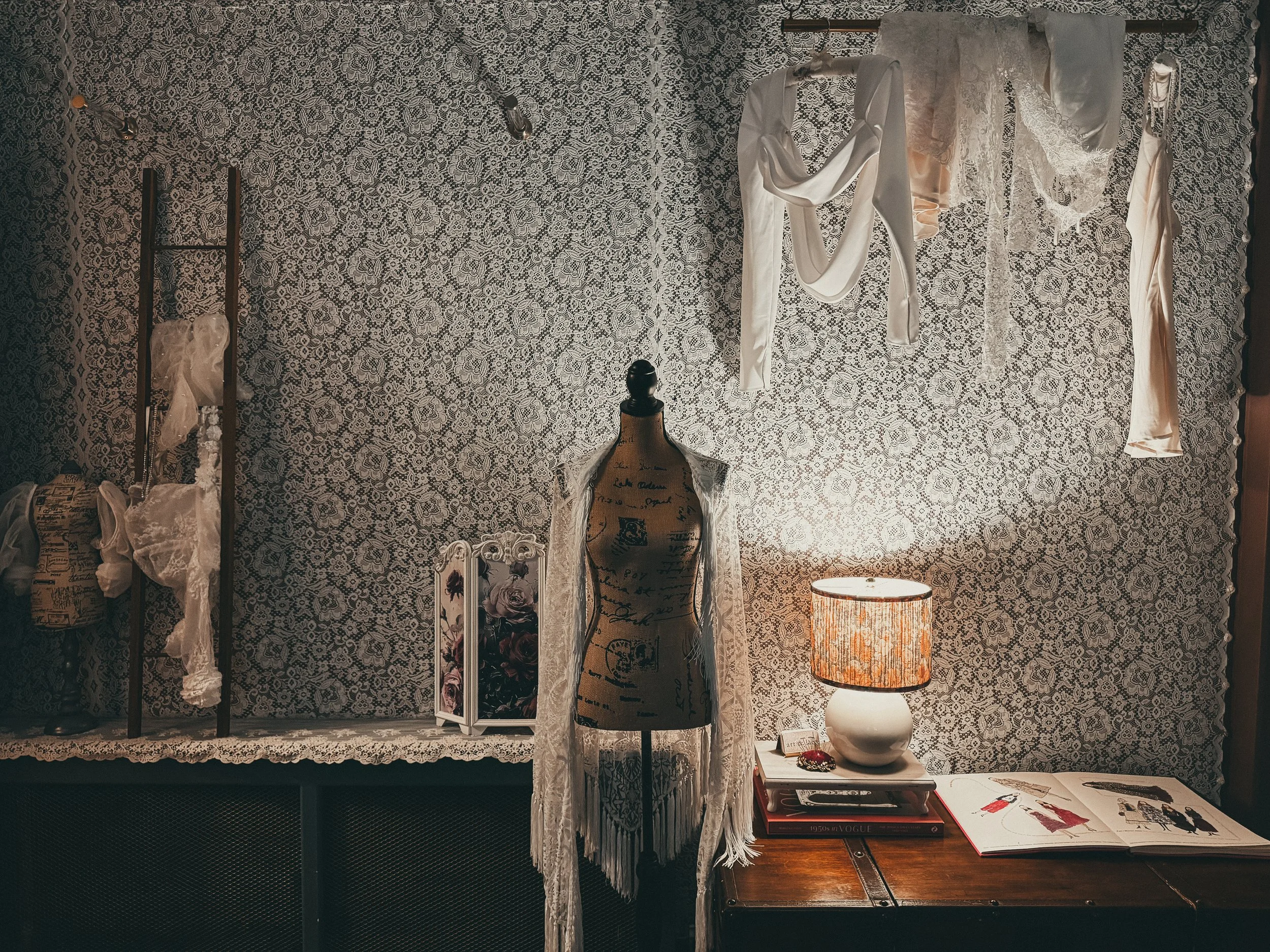 Vintage script mannequin form draped in fringed lace at Art & Lace Bridal — the private bridal styling studio in Somerset, MA.