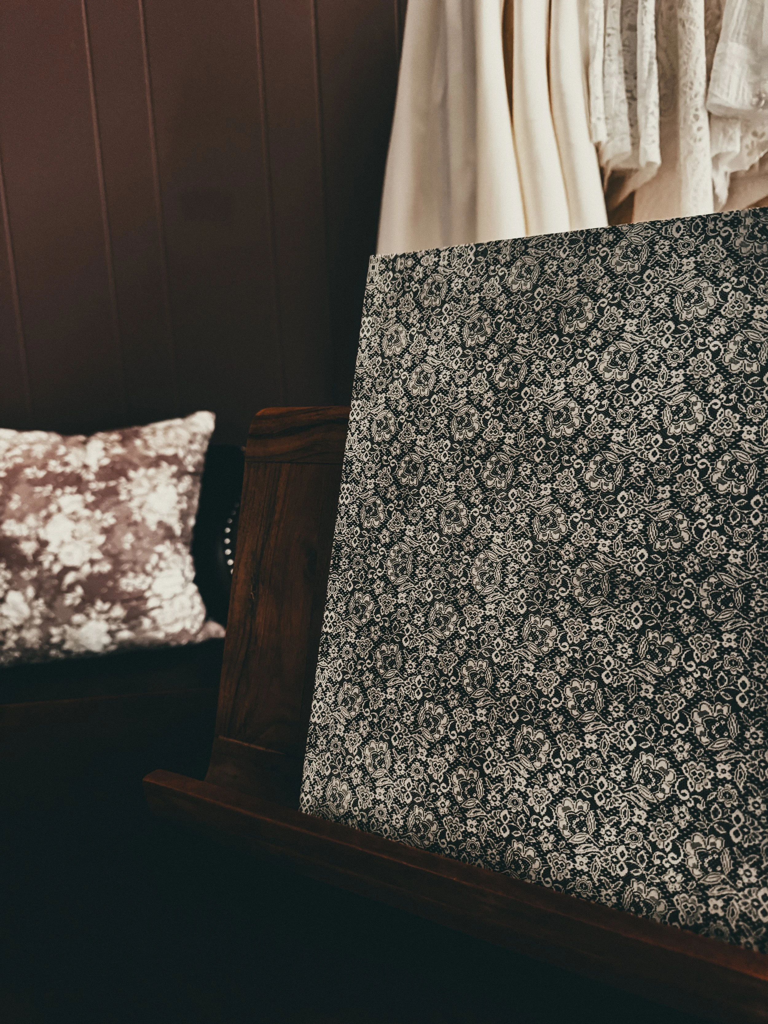 The Lace Journal — luxury bridal planning workbook by Art & Lace Bridal, hardcover with dark floral pattern styled on a wooden surface.