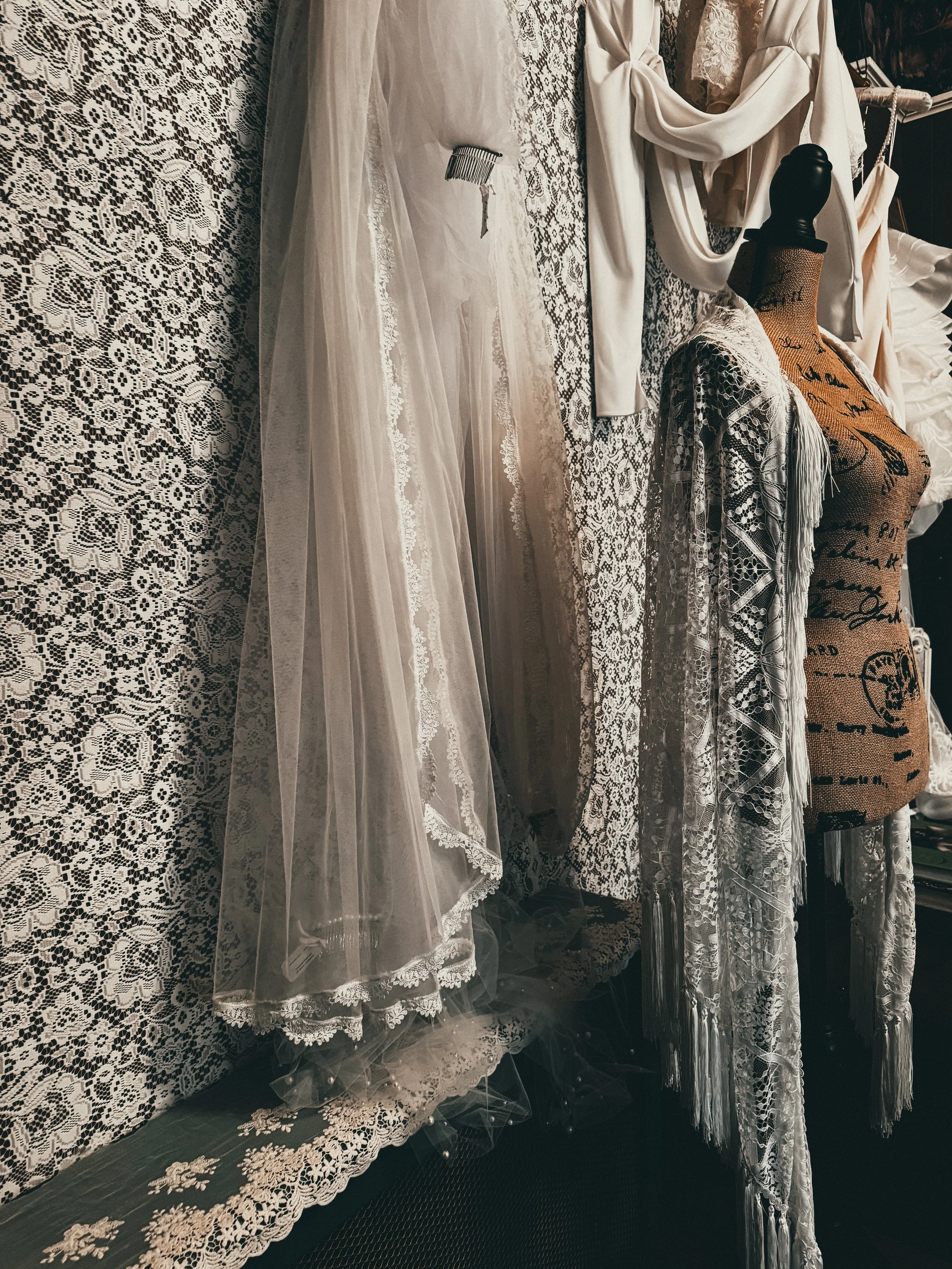 Handcrafted lace veils layered on a vintage dress form — Veil Atelier Consultation at Art & Lace Bridal in Somerset, MA.