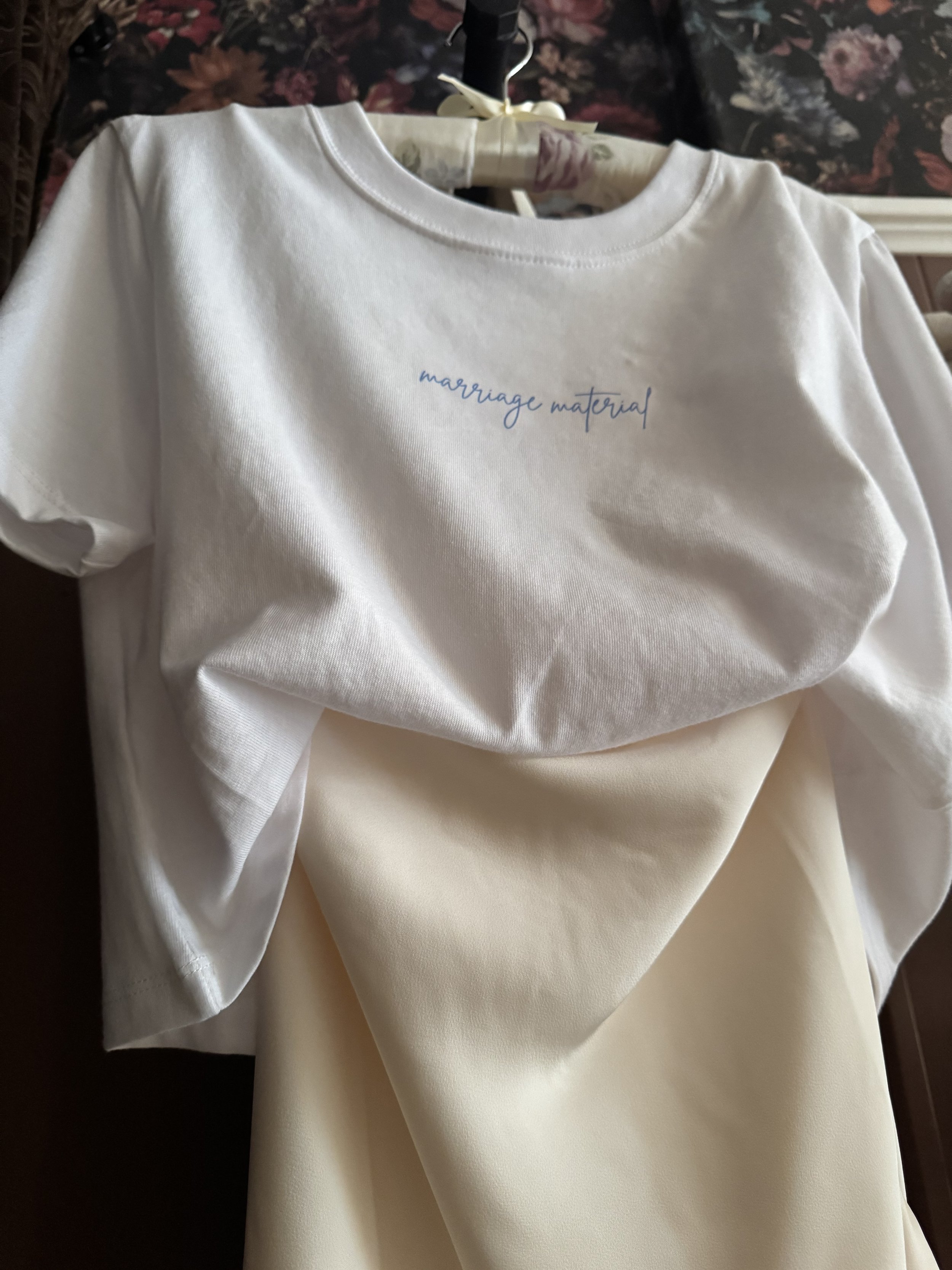 Front-facing shot of the Marriage Material Tee showing the delicate cursive graphic
