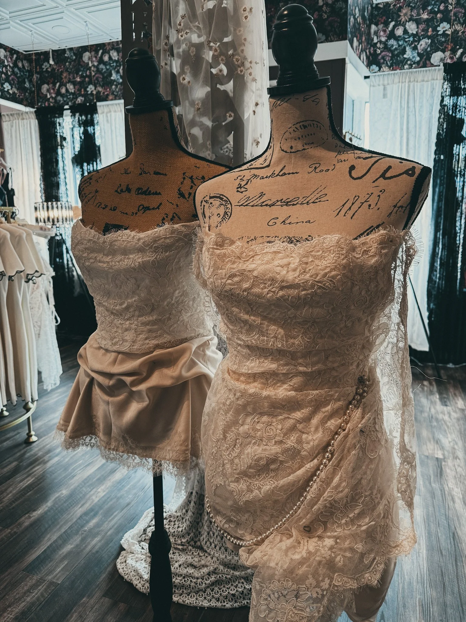 Custom-designed lace and satin bridal pieces on vintage dress forms — Mini Custom Design Session at Art & Lace Bridal Atelier.