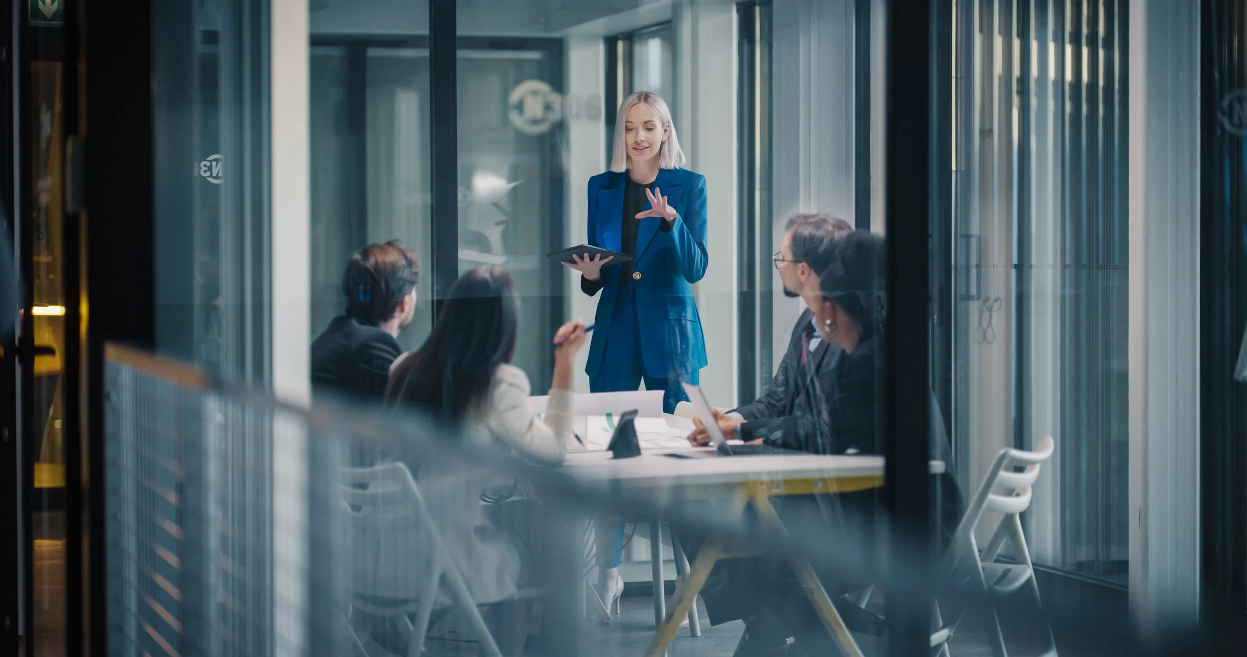 woman standing talking to a group of people