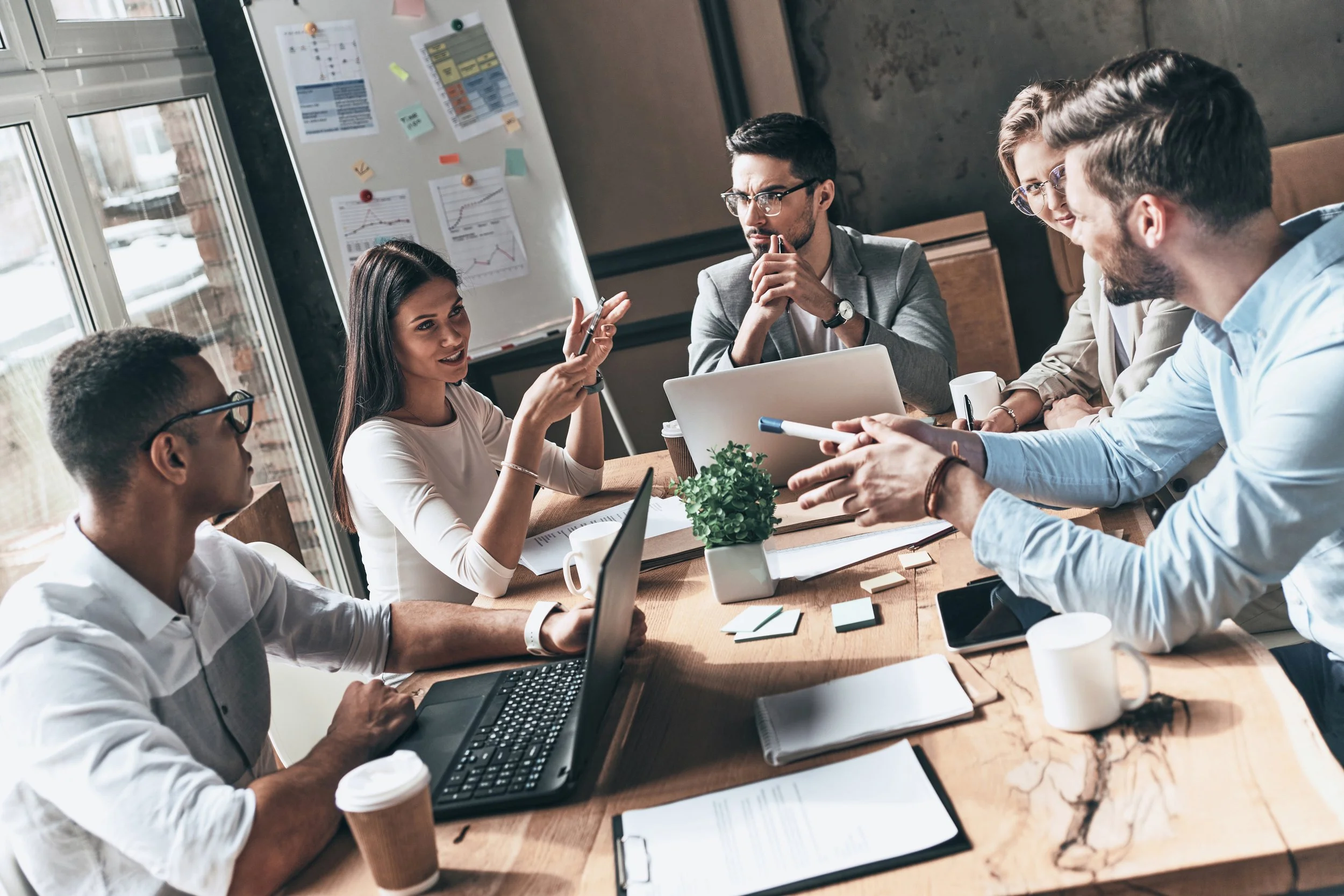 group of people sitting down at a table talking