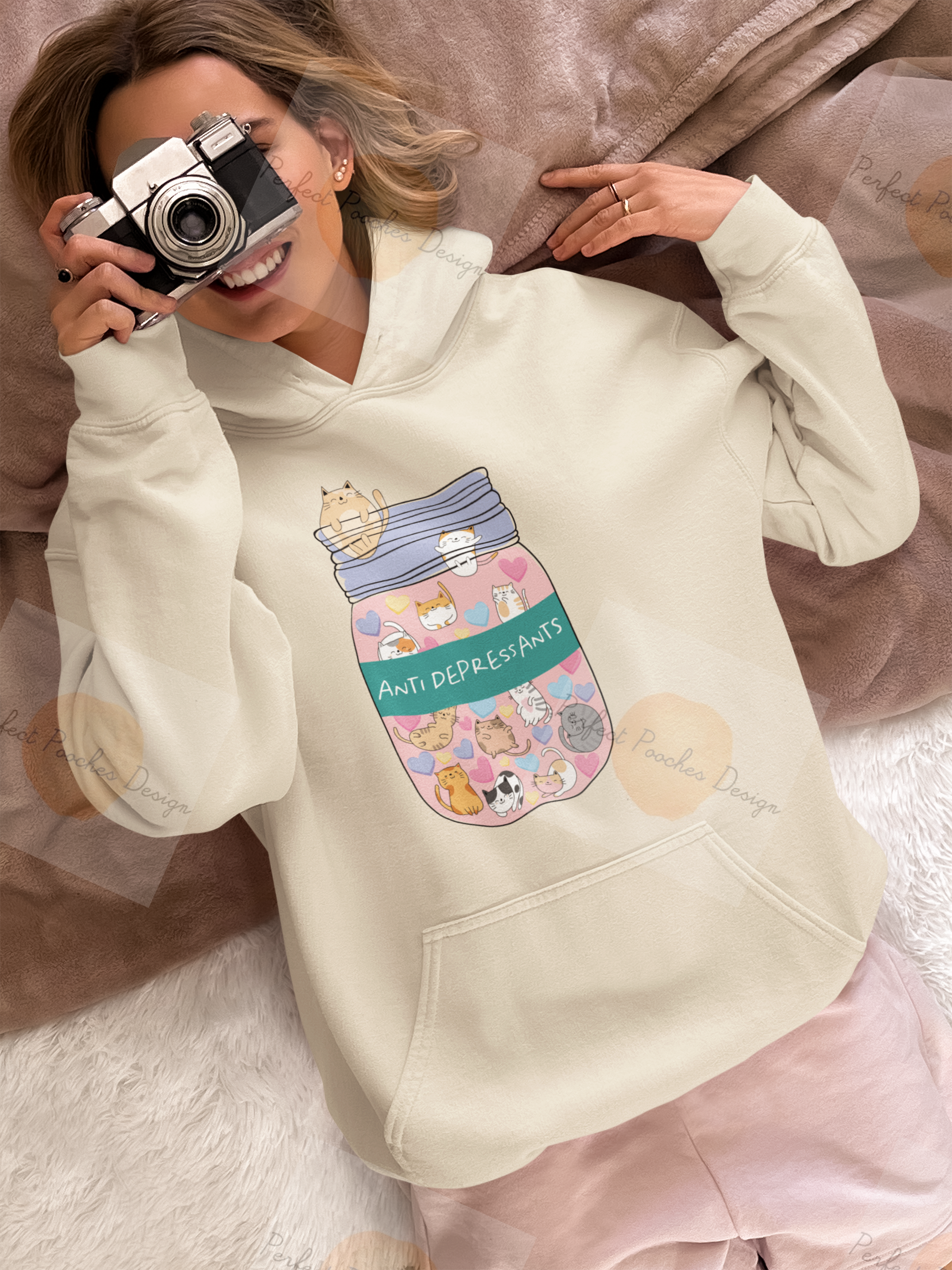 hoodie-mockup-of-a-woman-lying-in-bed-pointing-at-the-ceiling-with-a-vintage-camera-m37318.png
