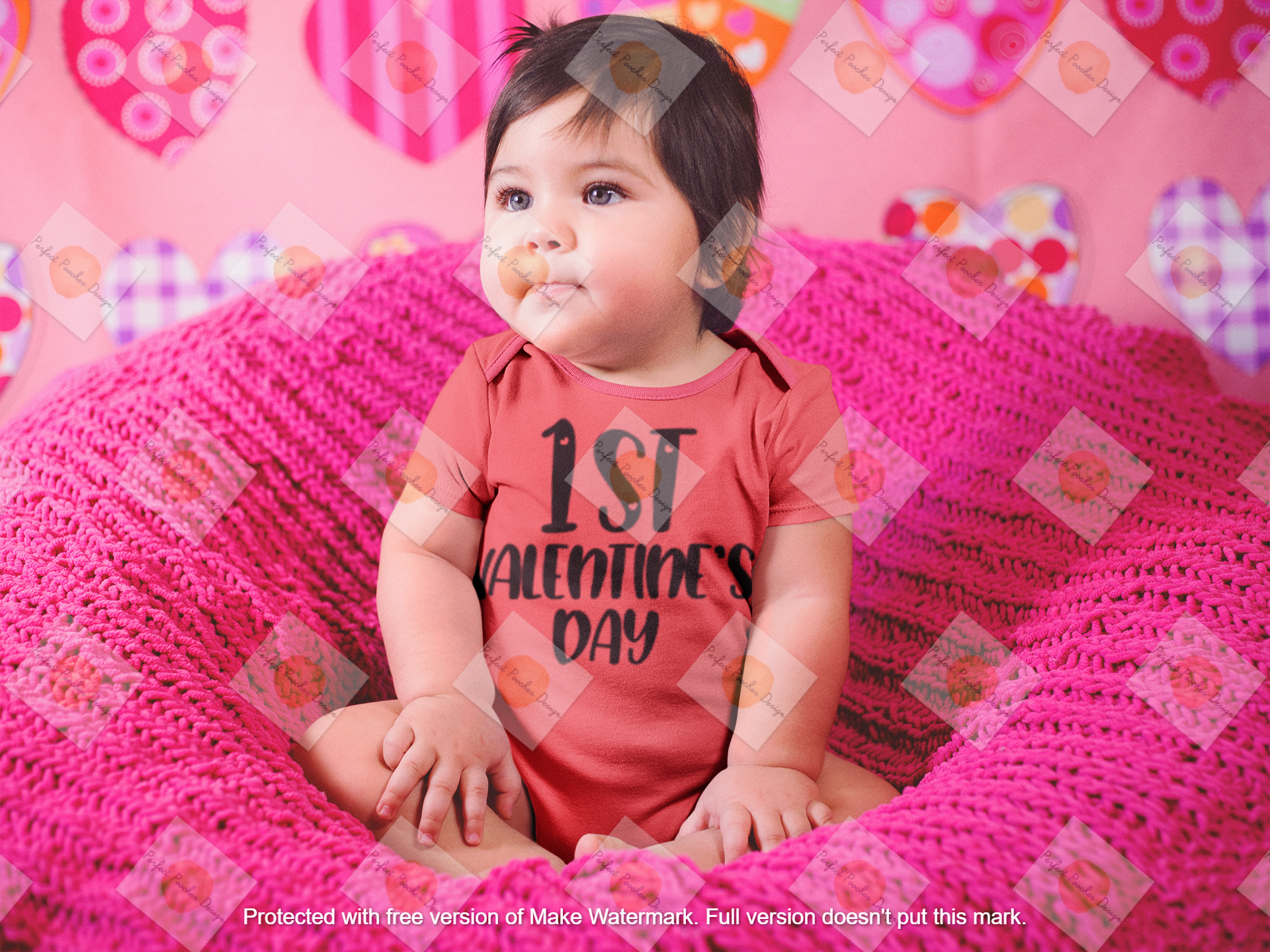 beautiful-little-baby-girl-sitting-on-a-pink-sofa-while-wearing-a-onesie-a14047--2.png