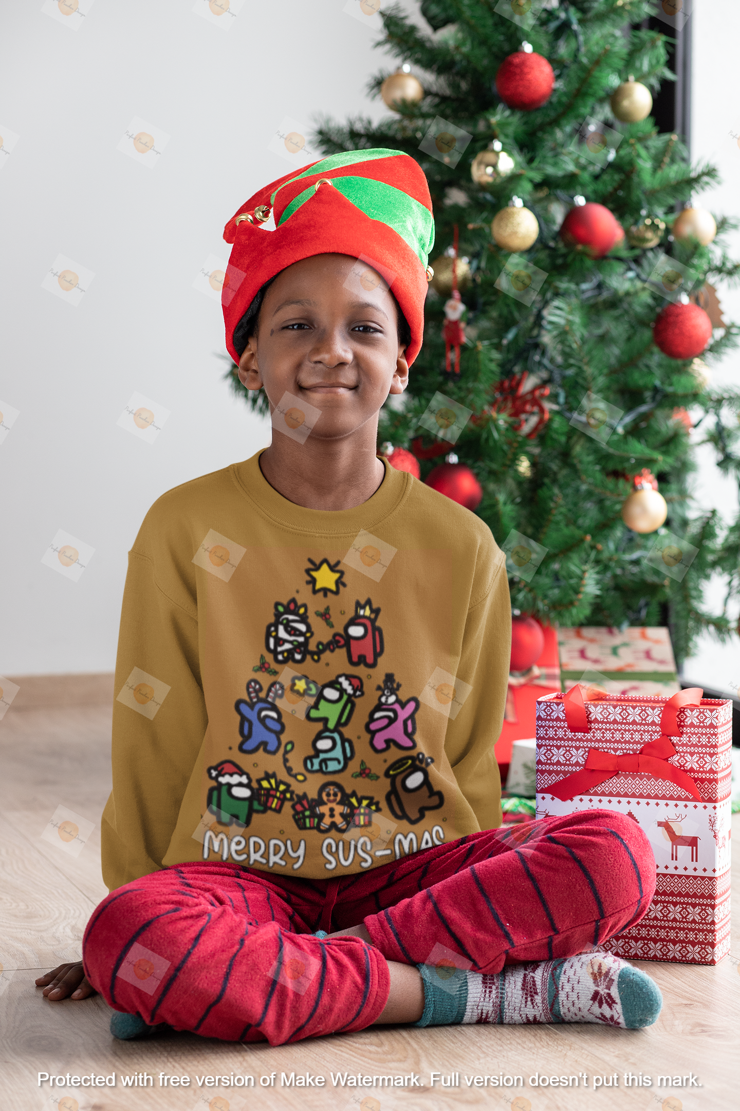 mockup-of-a-kid-with-a-crewneck-sweatshirt-sitting-next-to-a-christmas-tree-30358.png