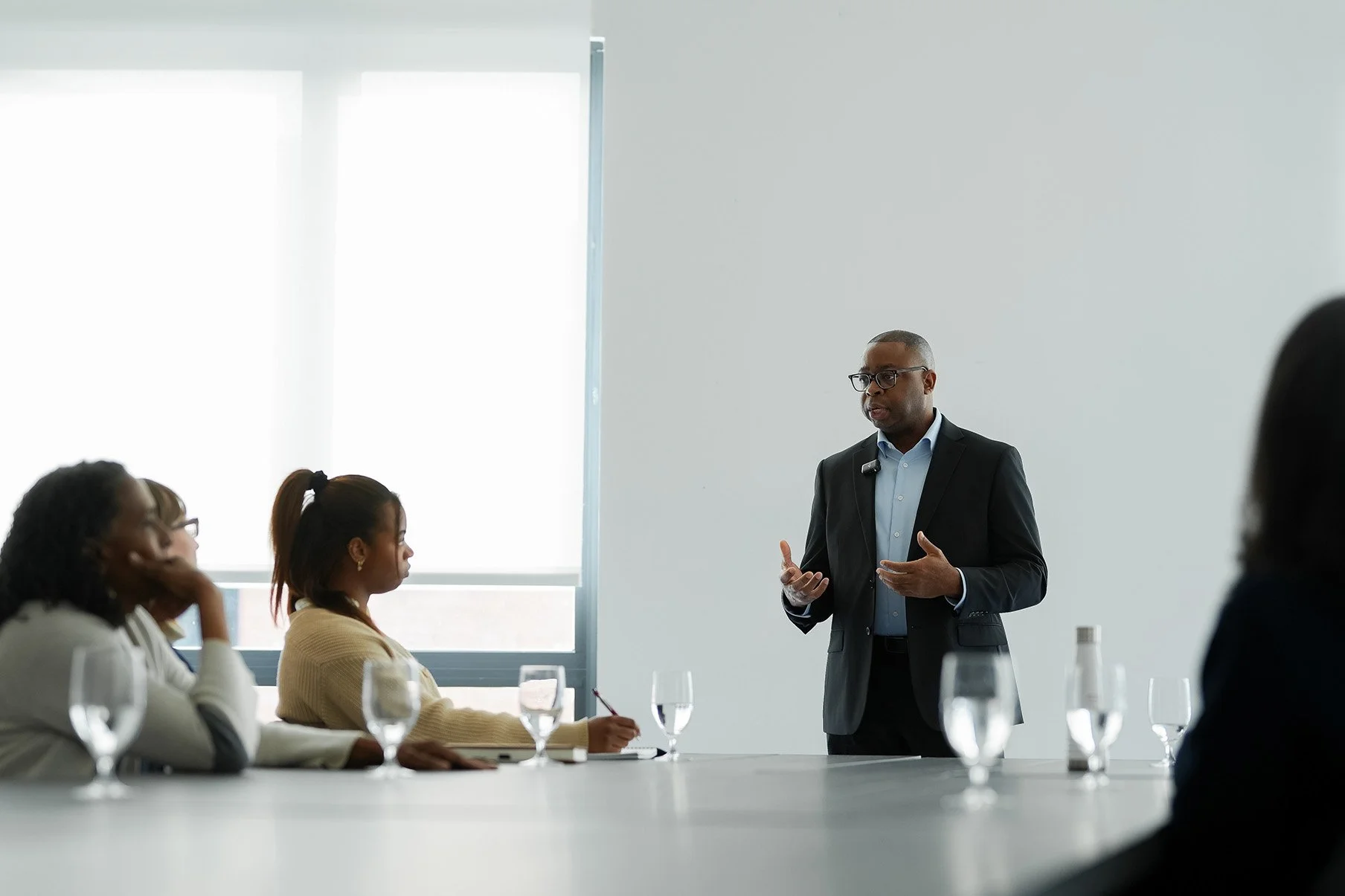 Man giving a presentation to seated audience in a conference room.