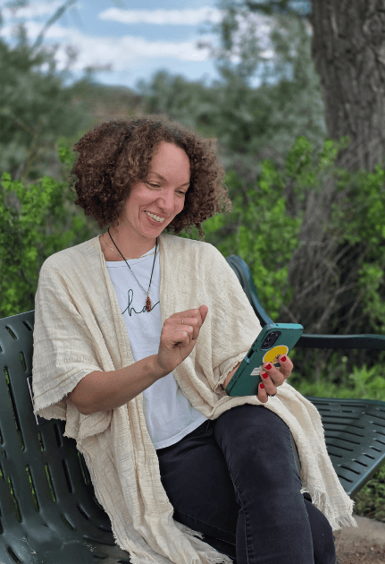 woman holding a phone and smiling