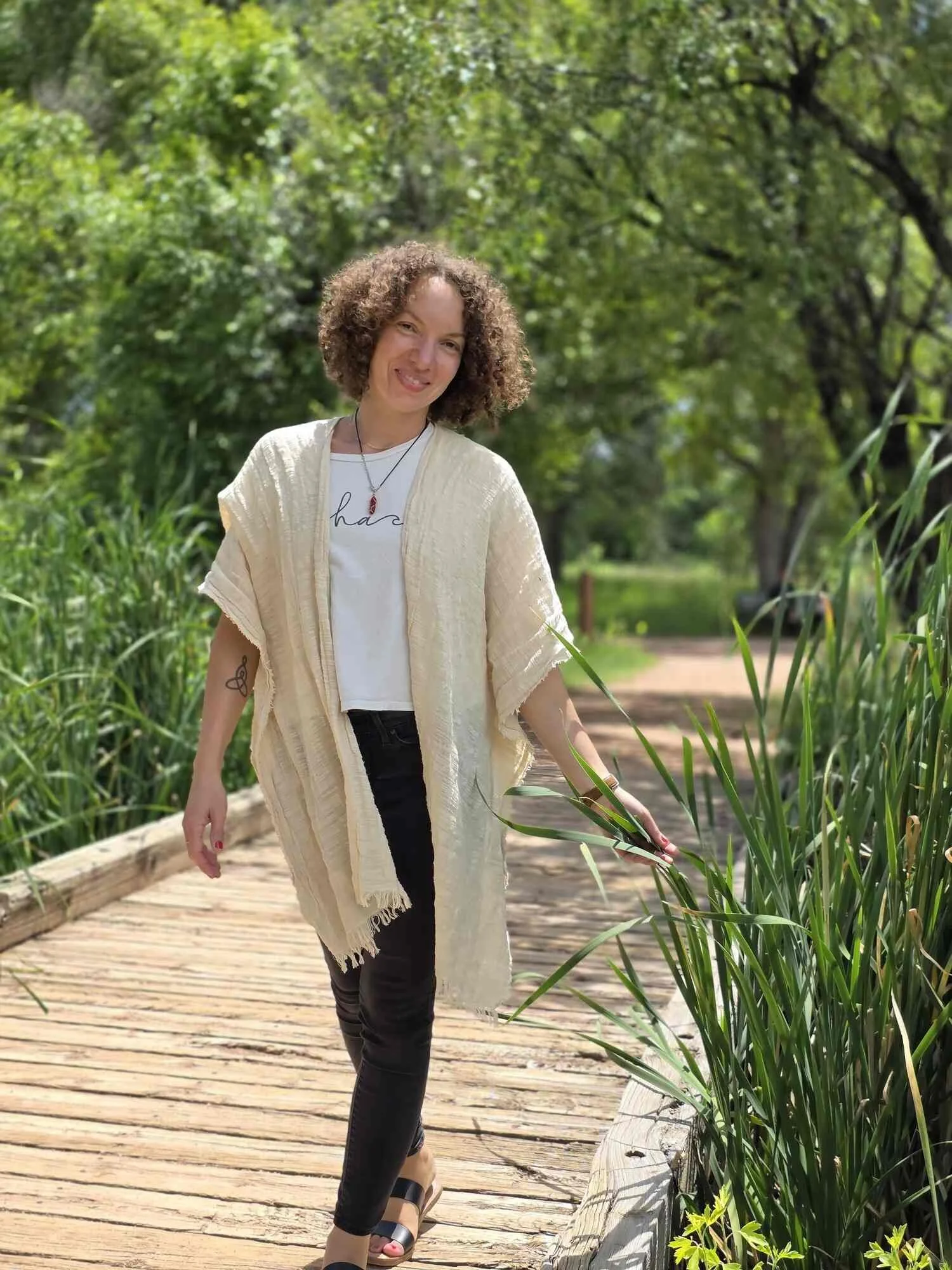 SEO copywriter and content marketing strategist, Stéphanie McGuirt, walking on a wooden bridge surrounded by greenery