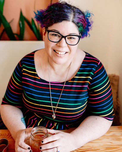 Picture of a smiling young women wearing colorful shirt