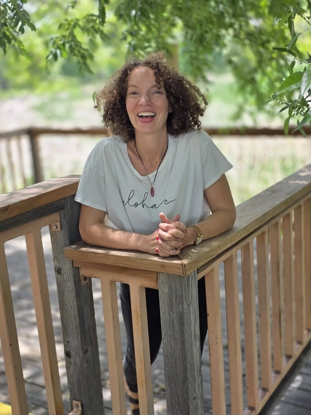 Copywriter Stéphanie McGuirt laughing outdoors in Colorado