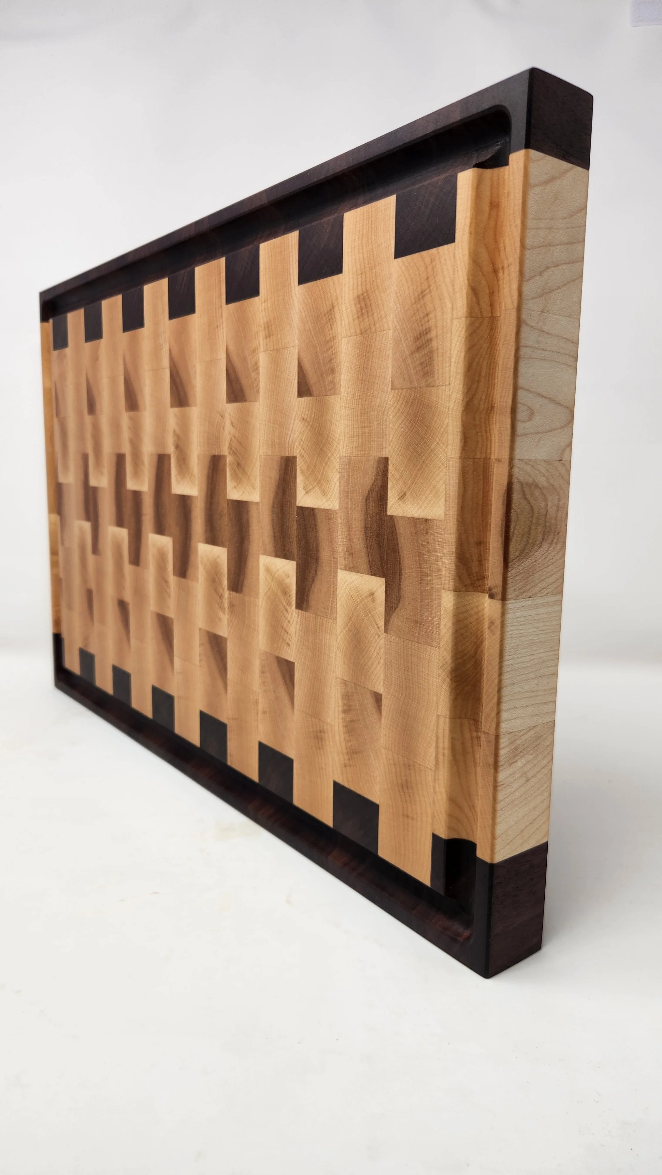 Maple walnut cutting board finished with food safe oil highlighting natural wood grain