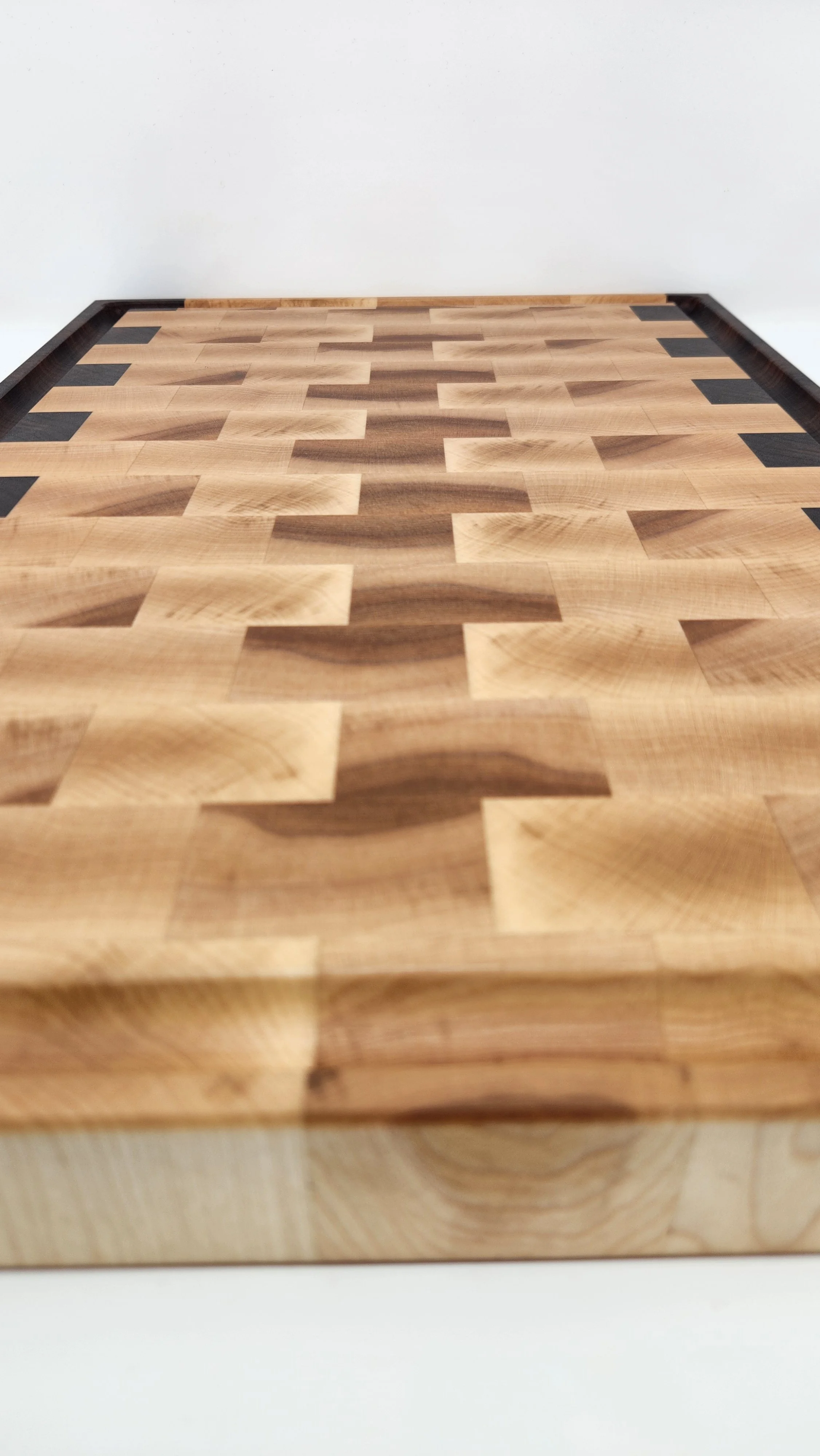 Thick end grain cutting board showing solid maple and walnut hardwood construction