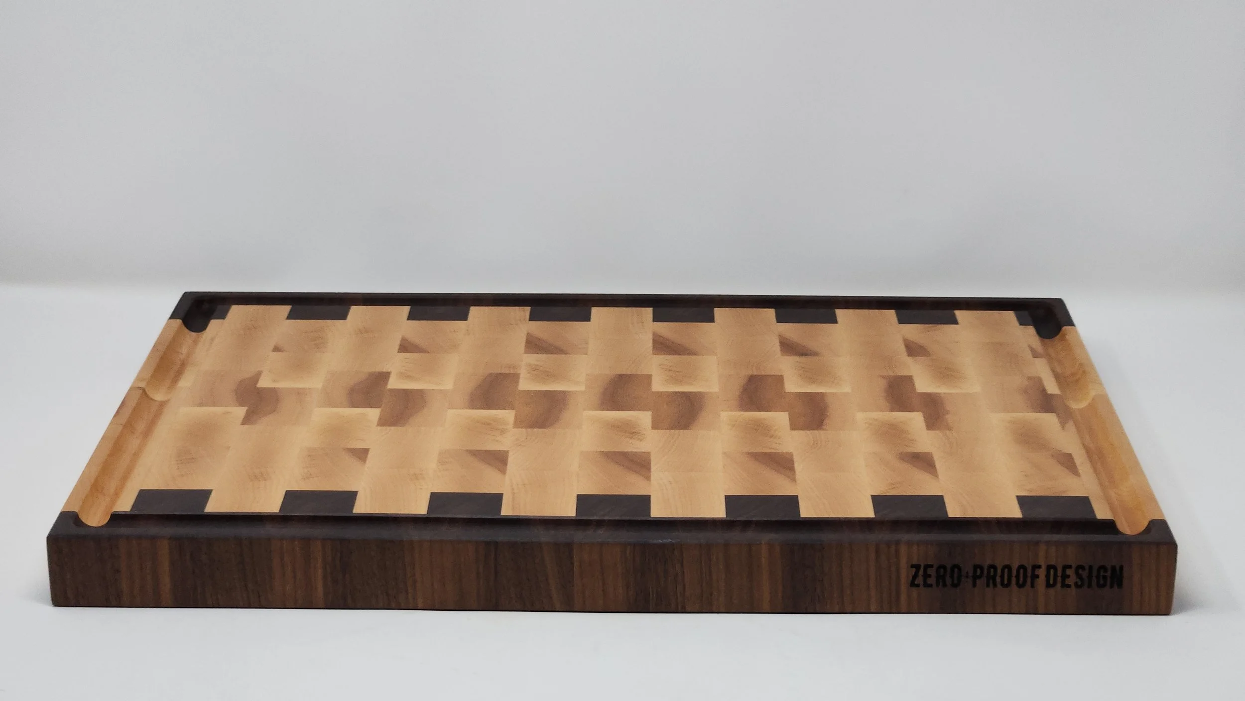 Large maple and walnut end grain cutting board on kitchen counter for food prep