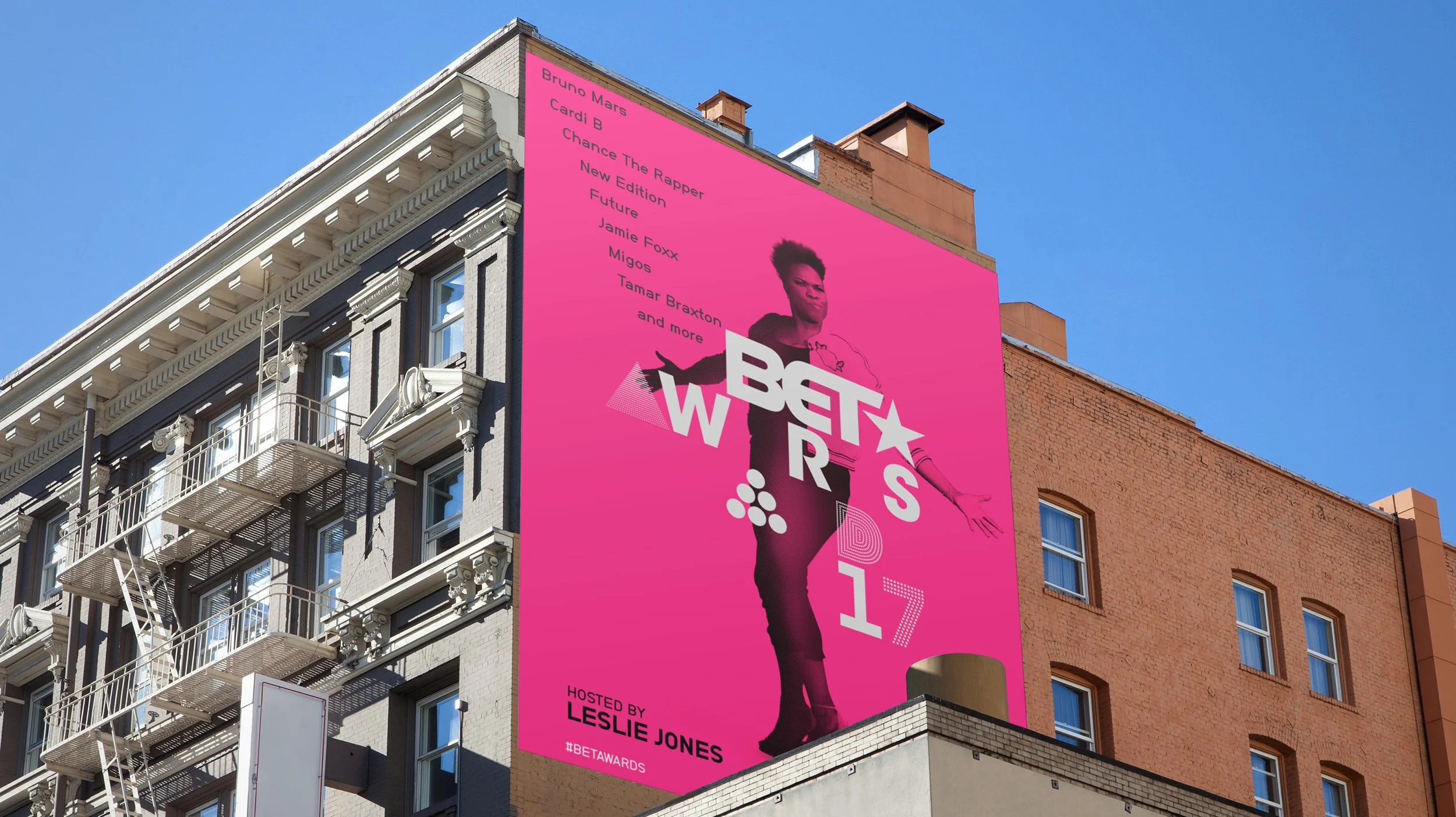 Bold pink BET Awards 2017 billboard featuring Leslie Jones and event lineup details