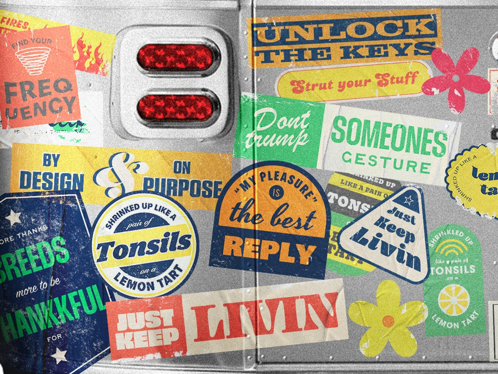 Colorful retro sticker collage applied to an Airstream trailer surface, featuring bold typography, vintage textures, and playful phrases layered across metal panels.