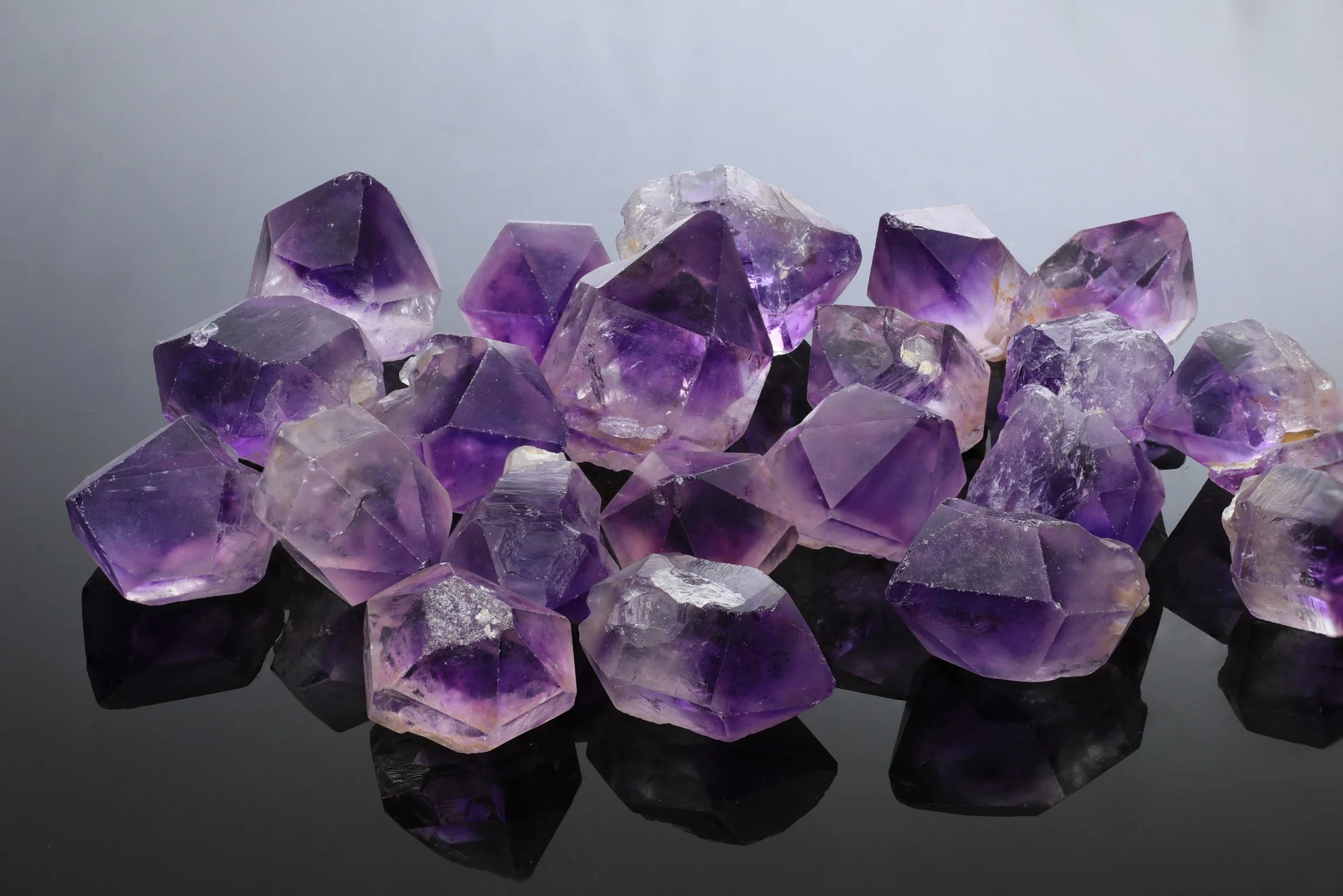 Australian Binbee amethyst crystals as they come from the earth. Note that the colour saturation is situated in the tip making it ideal for cutting gems. However only a very small percentage are actually gem grade and suitable for faceting.