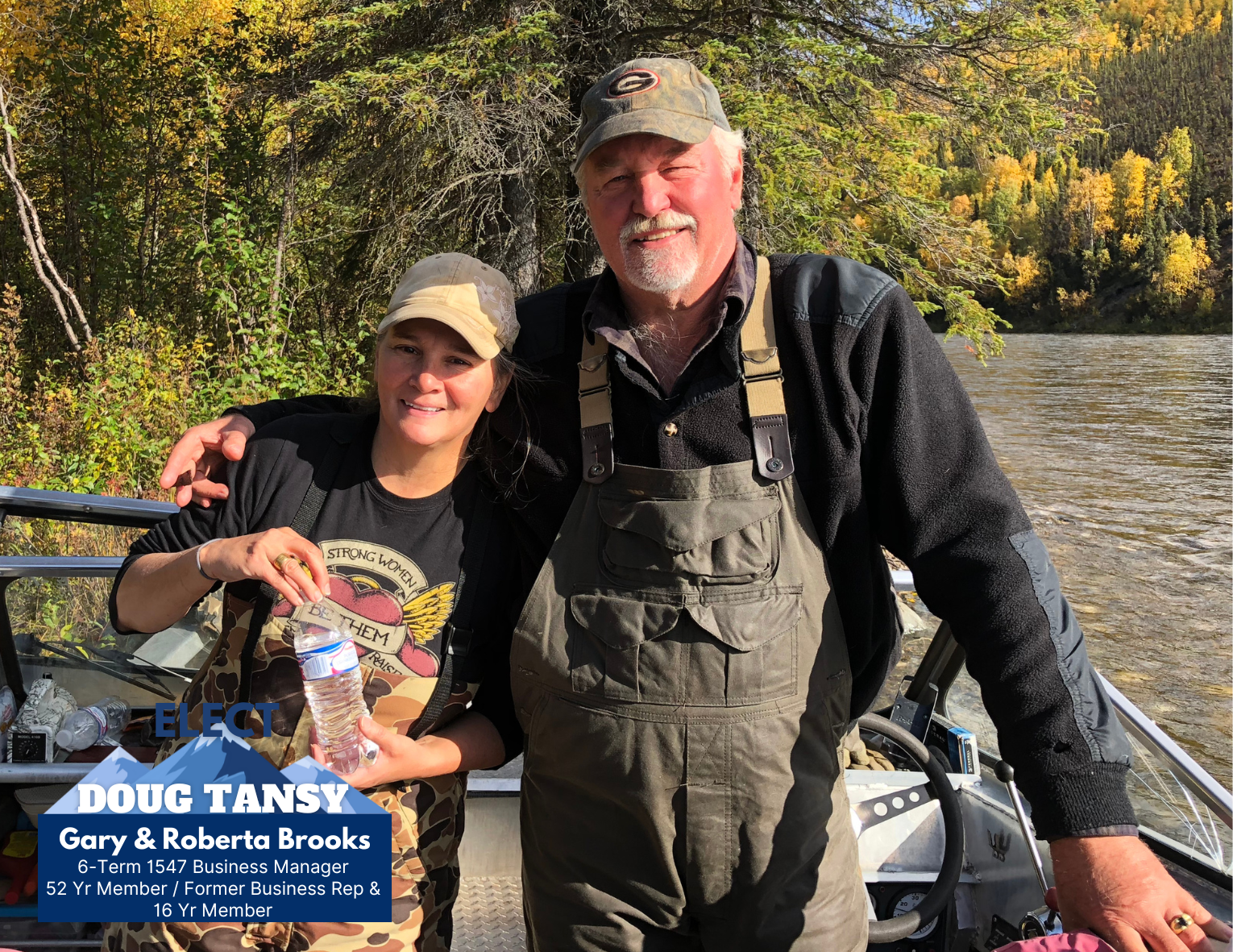 A man and woman standing on a boat by a river, surrounded by trees with autumn foliage. The woman is holding a water bottle, and the man has his arm around her. The background features a scenic river and forested hills.