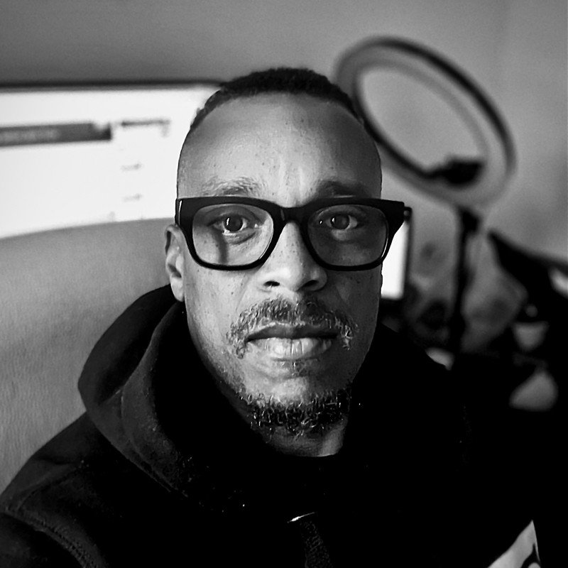 A picture of a black man wearing glasses