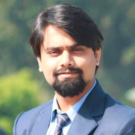 A man with a beard in a suit