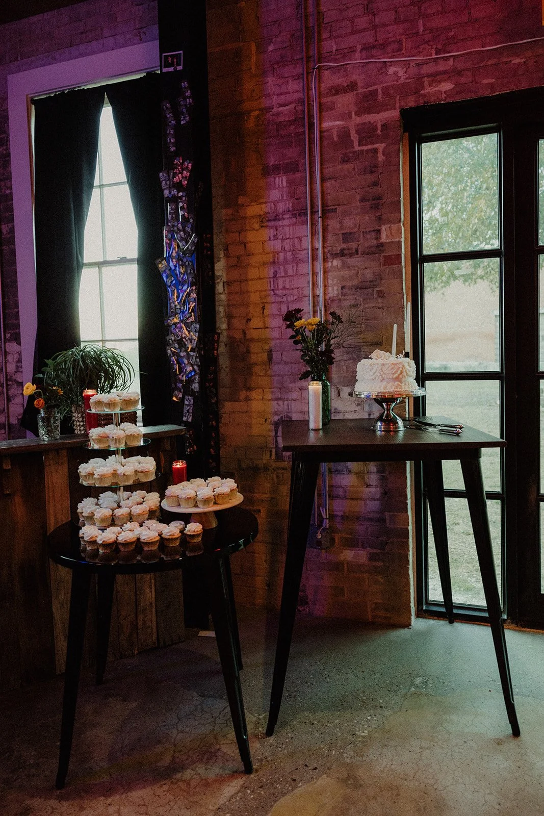 Cake and cupcakes arranged beside an exposed brick wall for a wedding at Duetts.