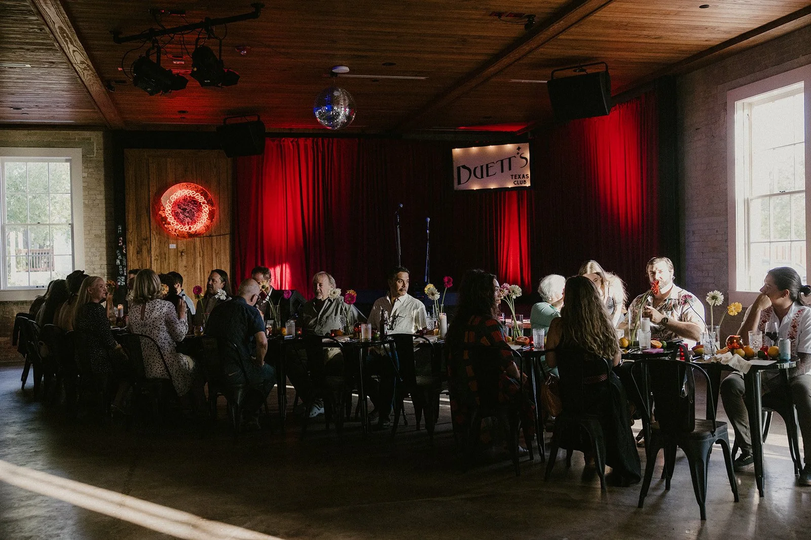 Guests gathered for dinner in front of the red-curtained stage at Duetts Texas Club in Martindale.