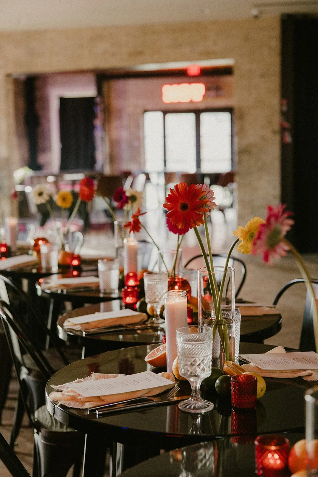 Flowers, candles, and place settings on an event dinner table at Duetts.