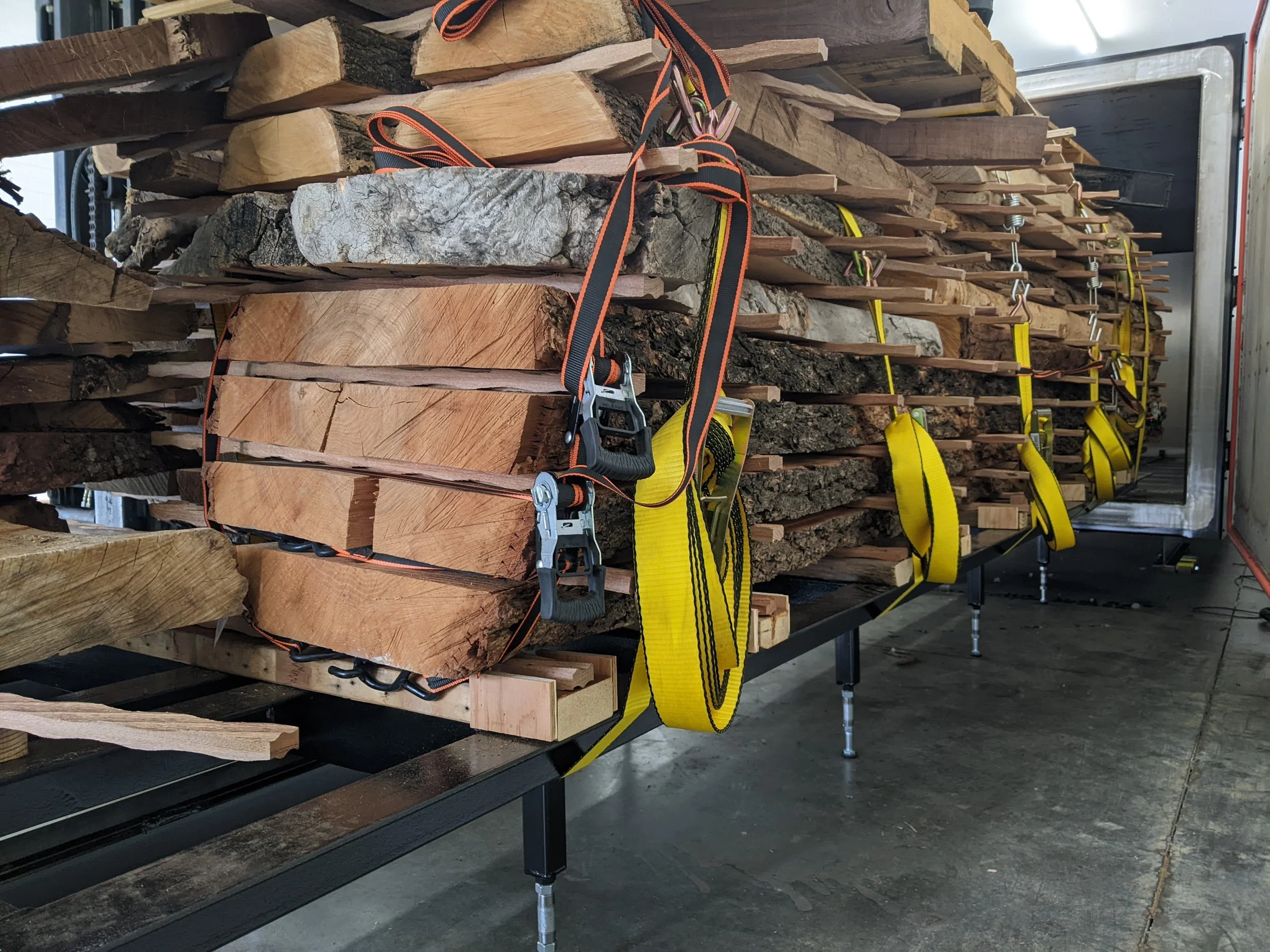 Stickered live edge slabs being loaded into the iDry kiln