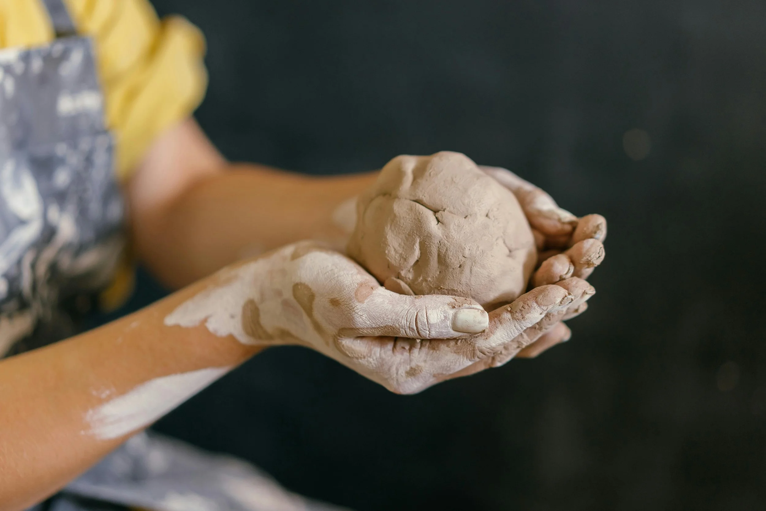 a young person creating clay art while having fun