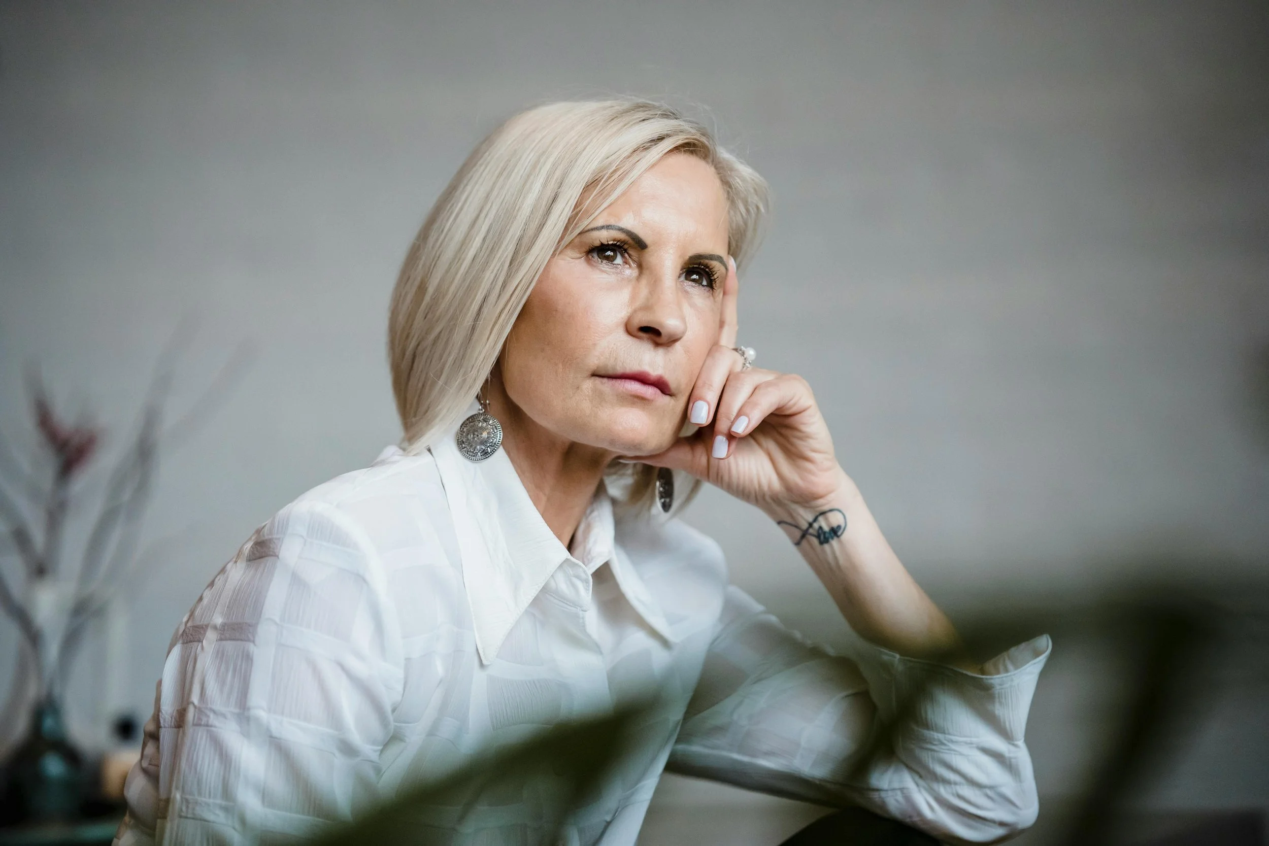 a middle aged woman contemplating the pros and cons of changing careers