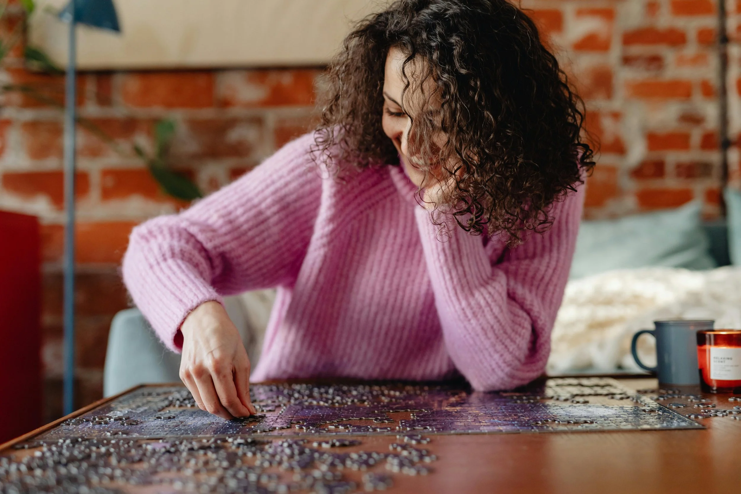 a woman finishing a puzzle