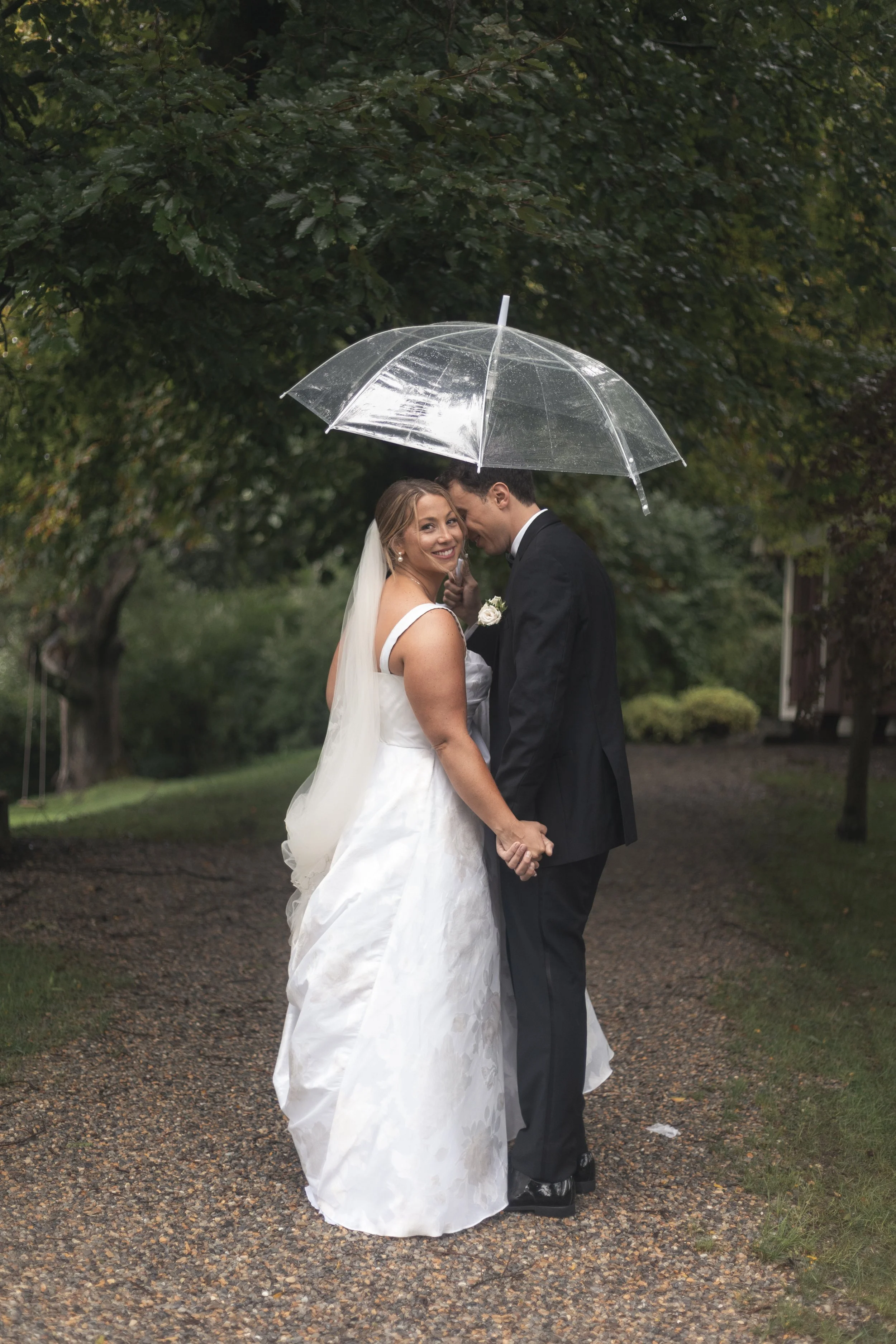 A bride and groom stand outside their wedding venue for portraits at Crossed Keys Estate in Andover, New Jersey. 