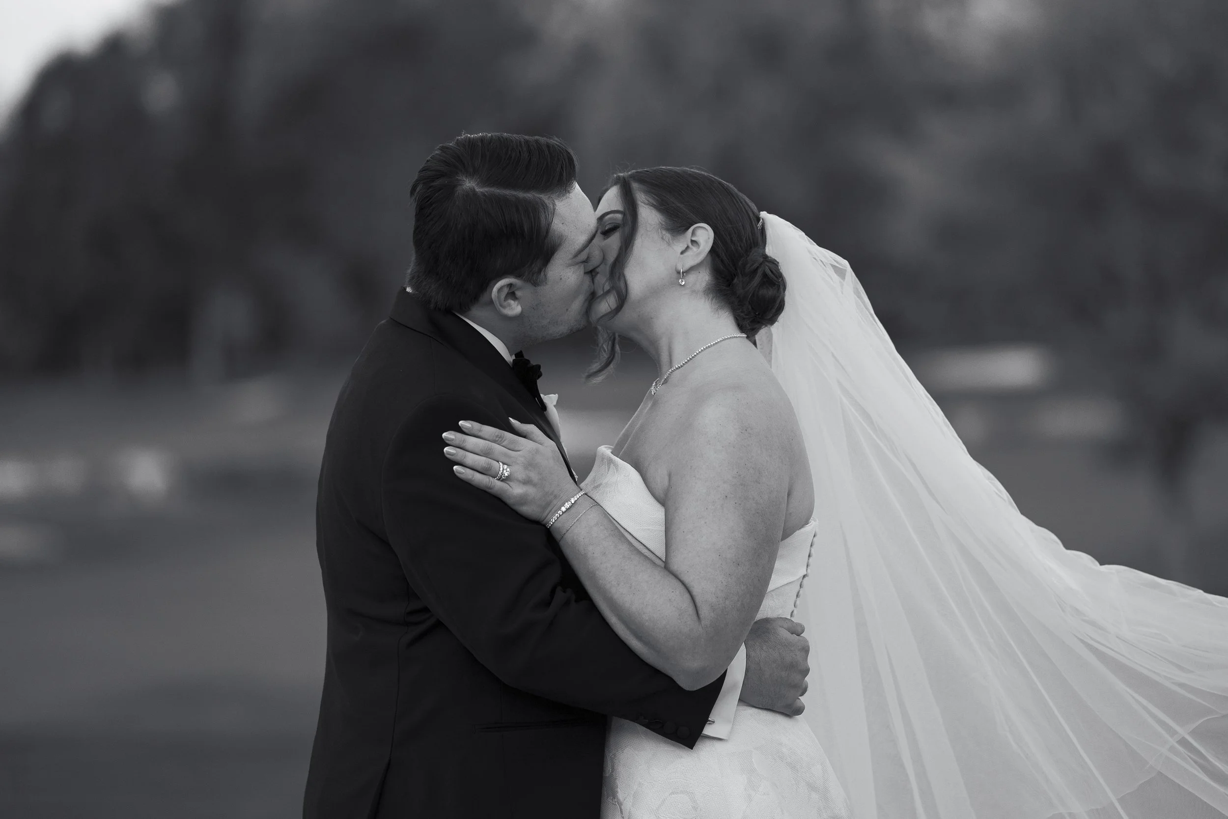 Bride and groom pose and kiss during their bridal portraits on the golf course at Cedar Hill Country Club in Livingston, NJ. 