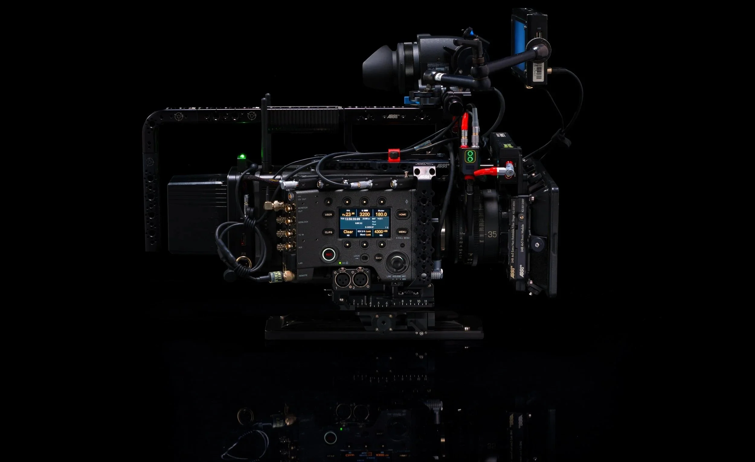 A professional digital cinema camera setup with various mounted components and a black background.