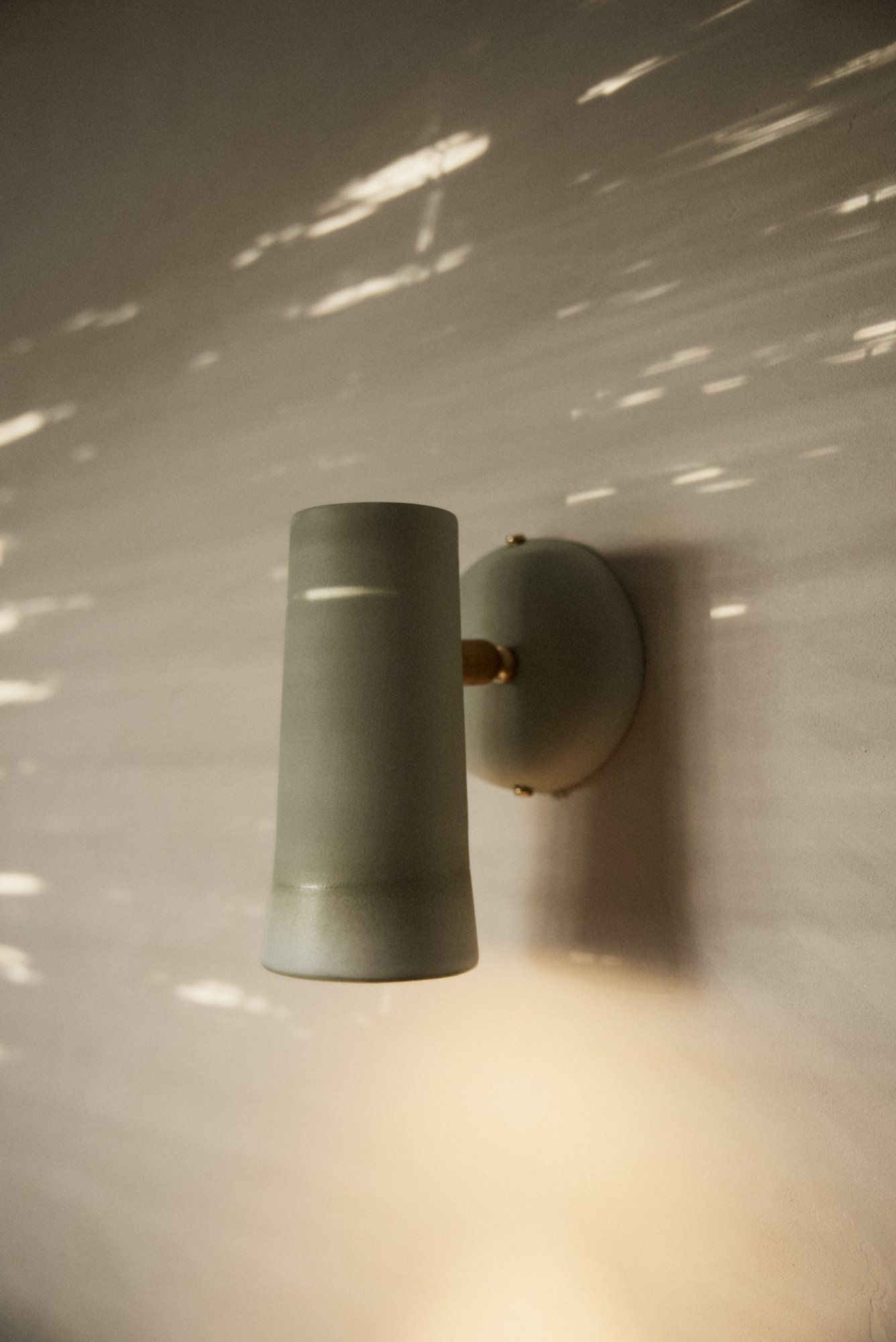 Designer wall lights in green porcelain