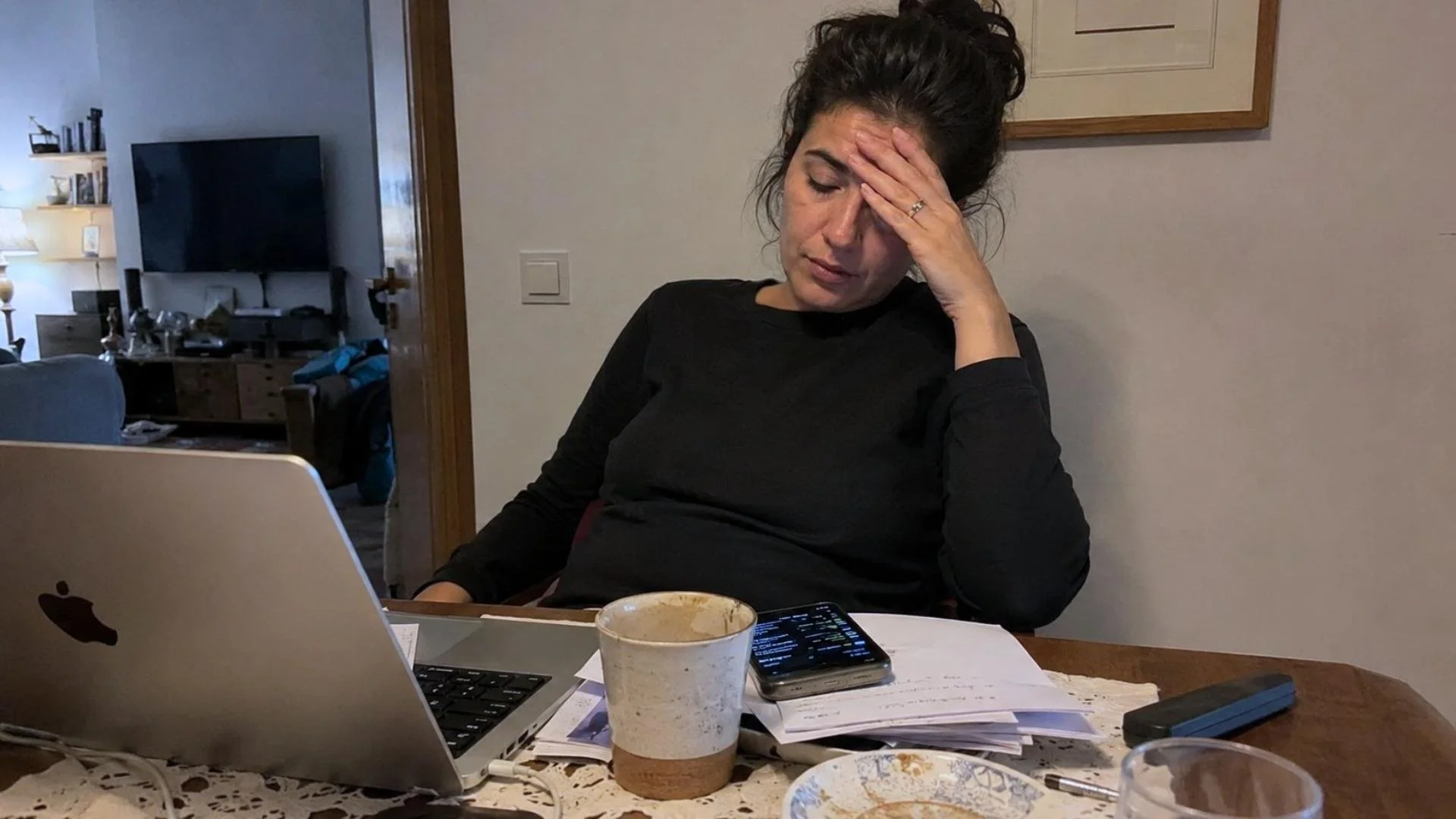 Levantine Arab woman feeling overwhelmed at a home workspace, showing “wallah ma fiyye” as being too tired to deal with something.