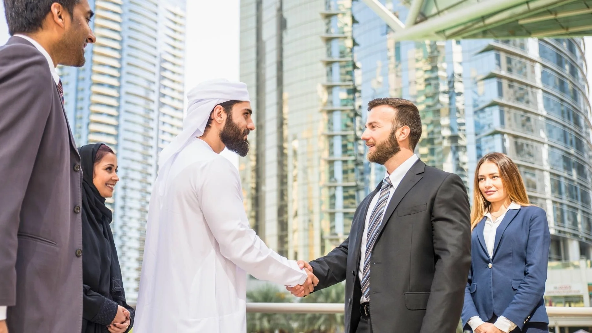 Arab and non-Arab professionals shaking hands during a business meeting in Ramadan