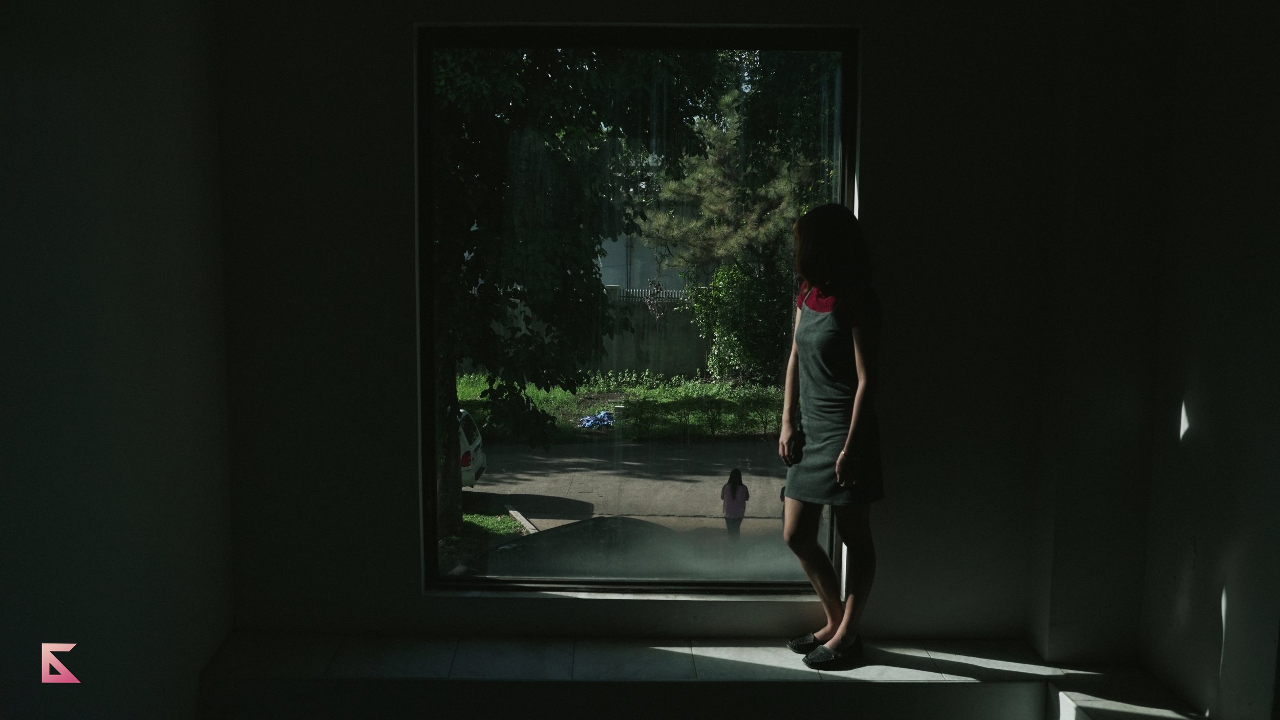 A girl looking thru a window