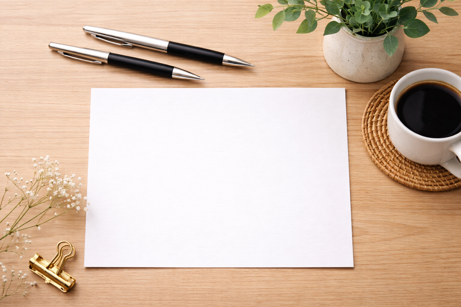 Blank document on a desk with pens and greenery, representing customised HR document preparation.