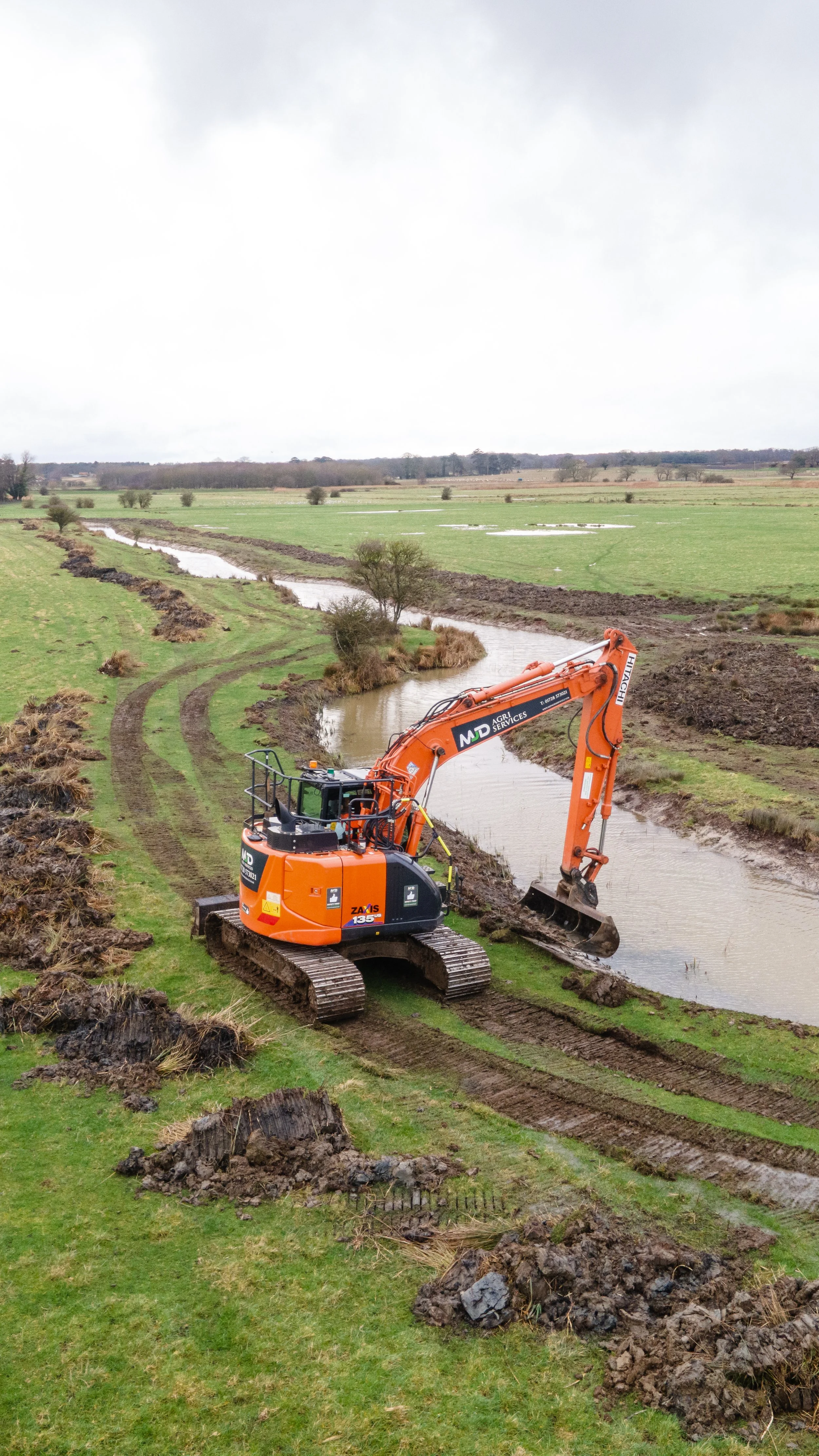 MJD excavator re-profiling a watercourse