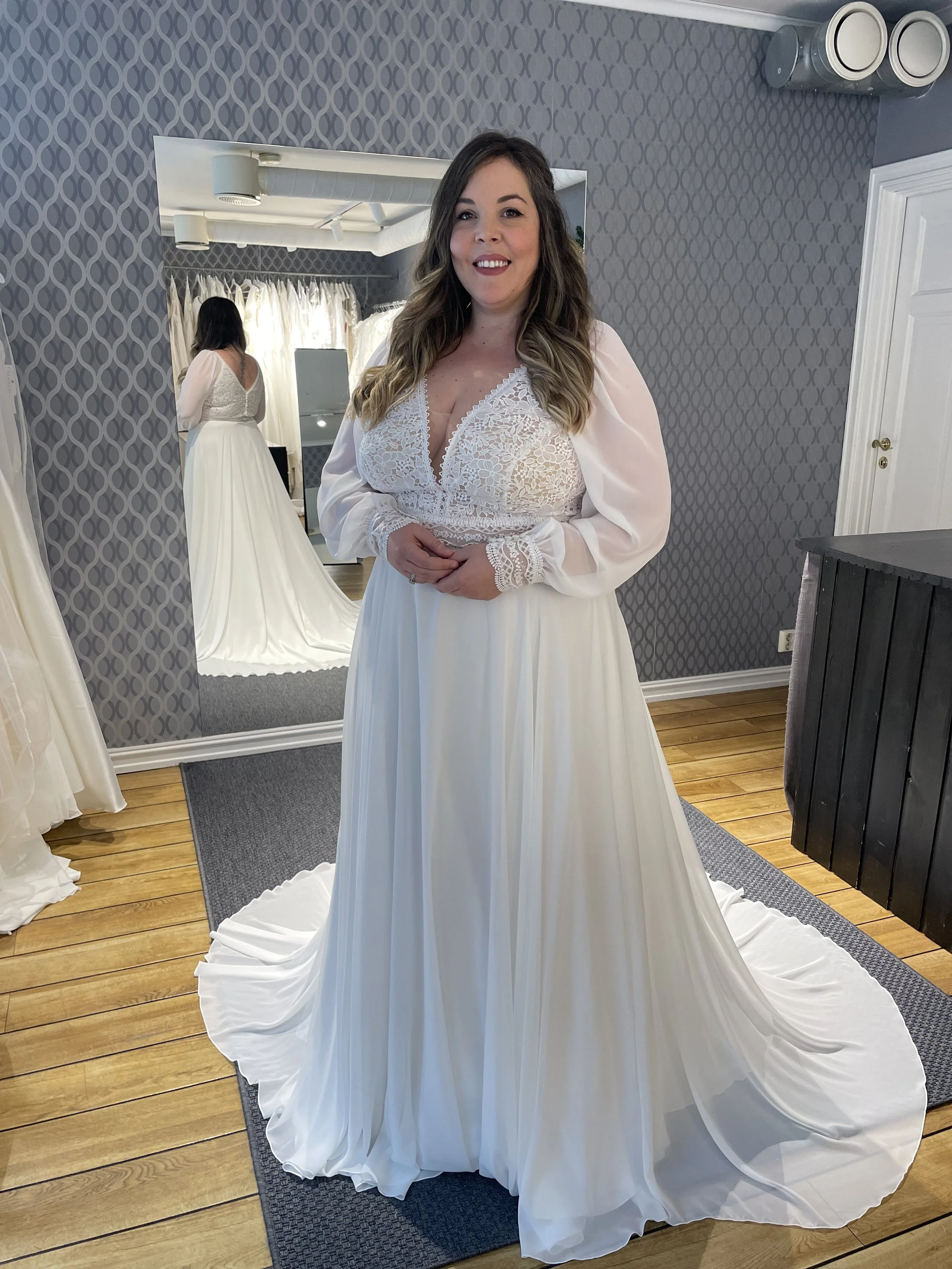 Nydelige Ursula er en populær modell i chiffon hos oss. Brudekjolen har en vakker blondetopp og lange ballongermer med matchende blondemansjetter og et enkelt skjørt. Denne er lett å like, for den er skikkelig fin! Dette er en av våre nye brudekjoler