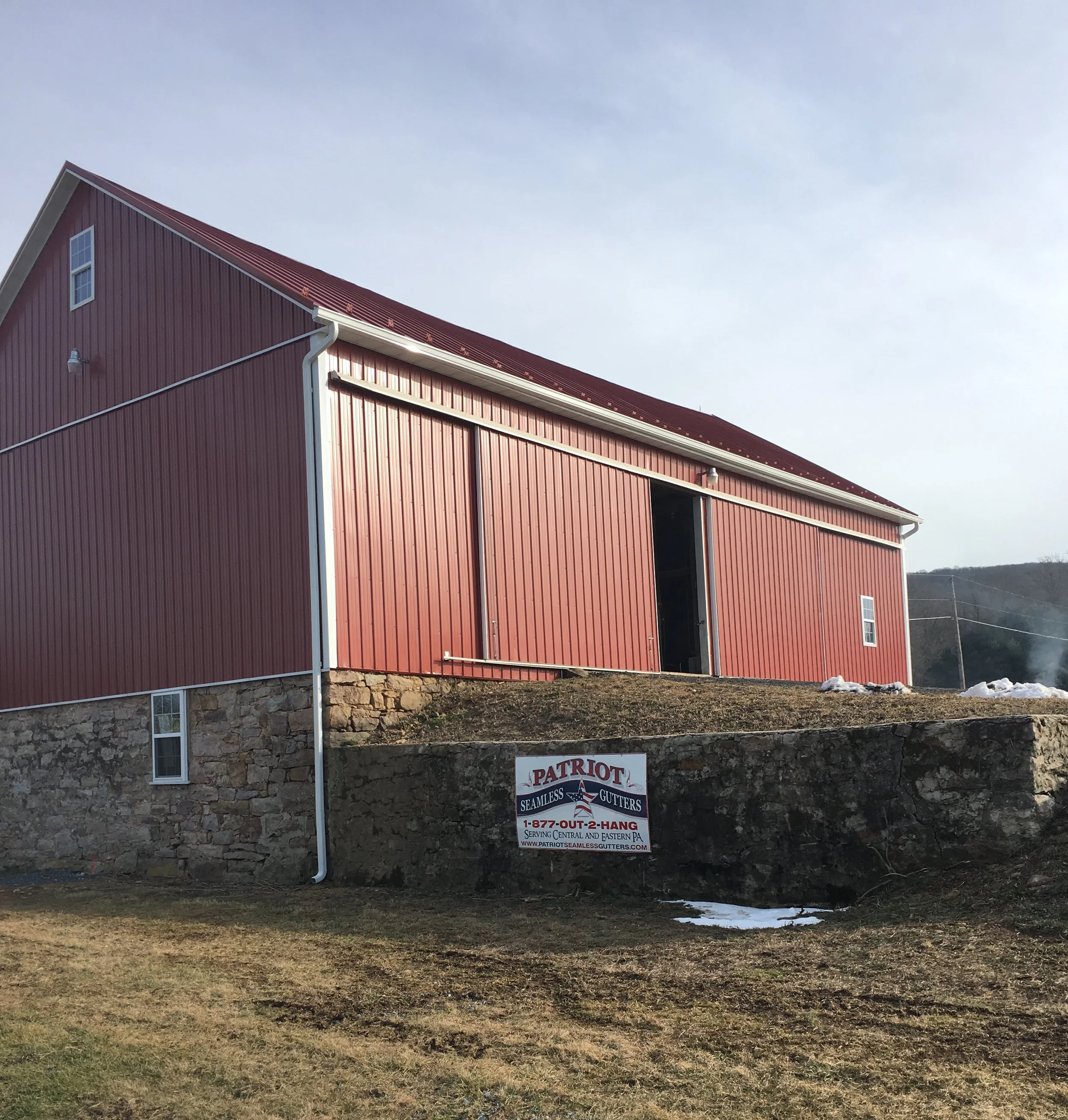 Custom installation of white K-gutter on a barn in Schuylkill County