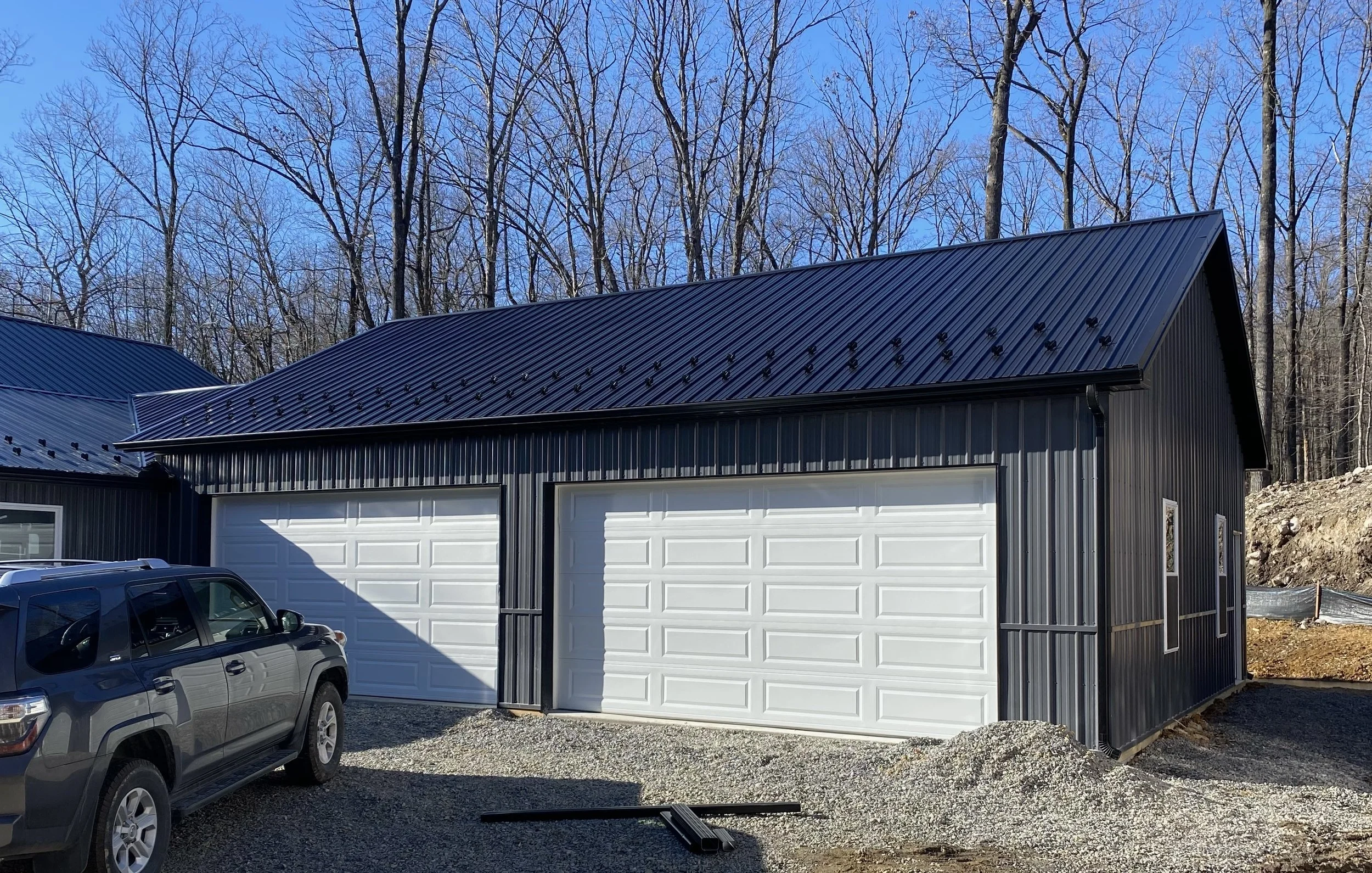 Snow guards and black gutter added to a metal roof.