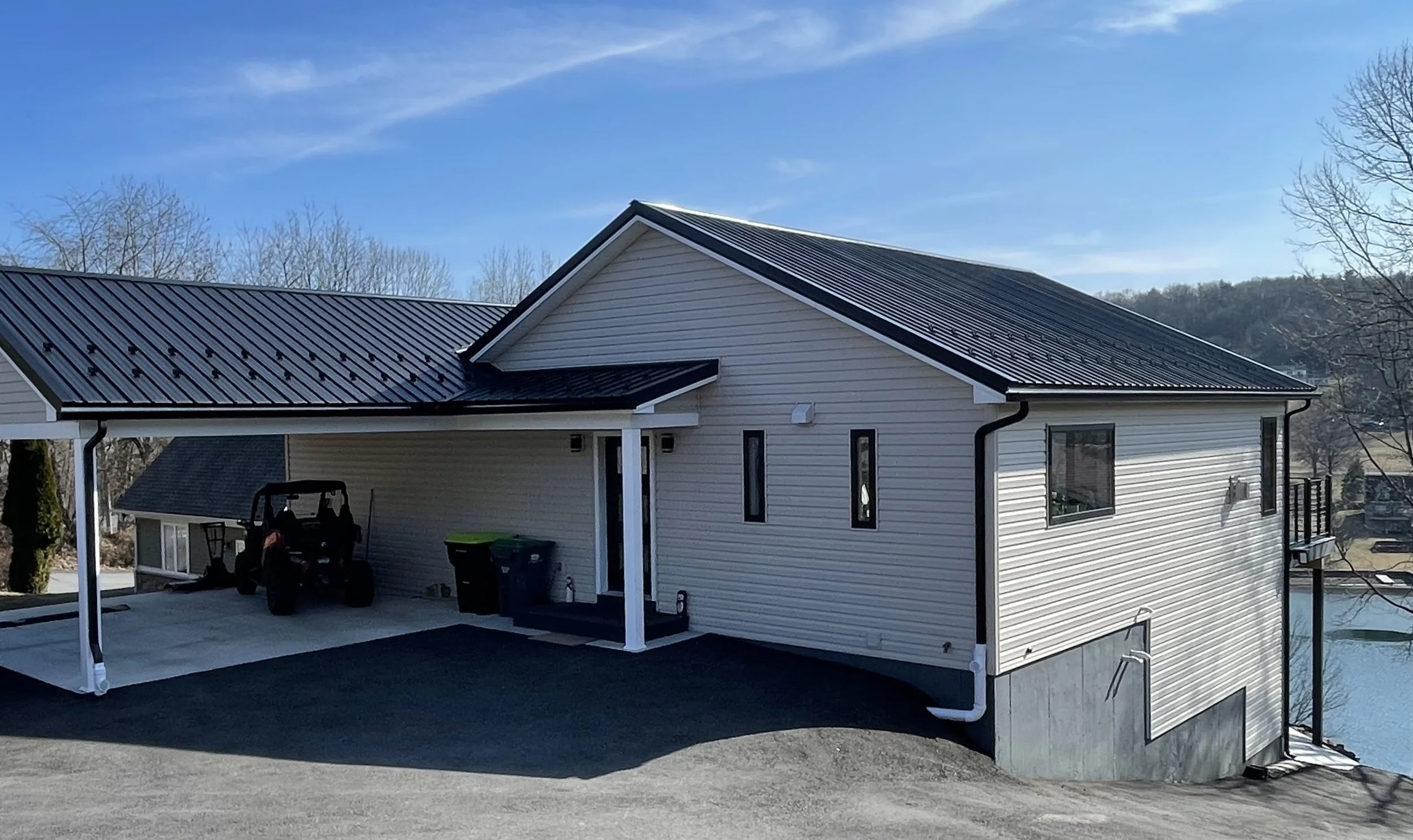 Snow guards and black gutter on a metal roof.