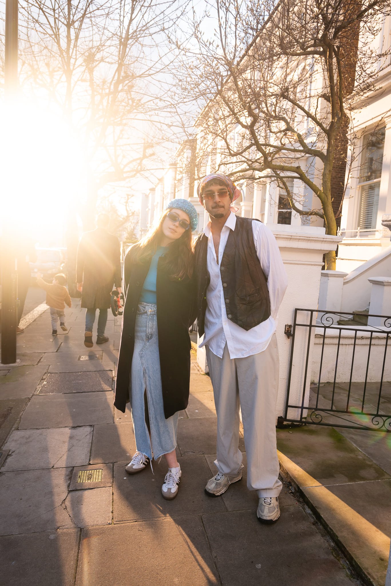 Man & Woman on London street with sunlight coming from the background