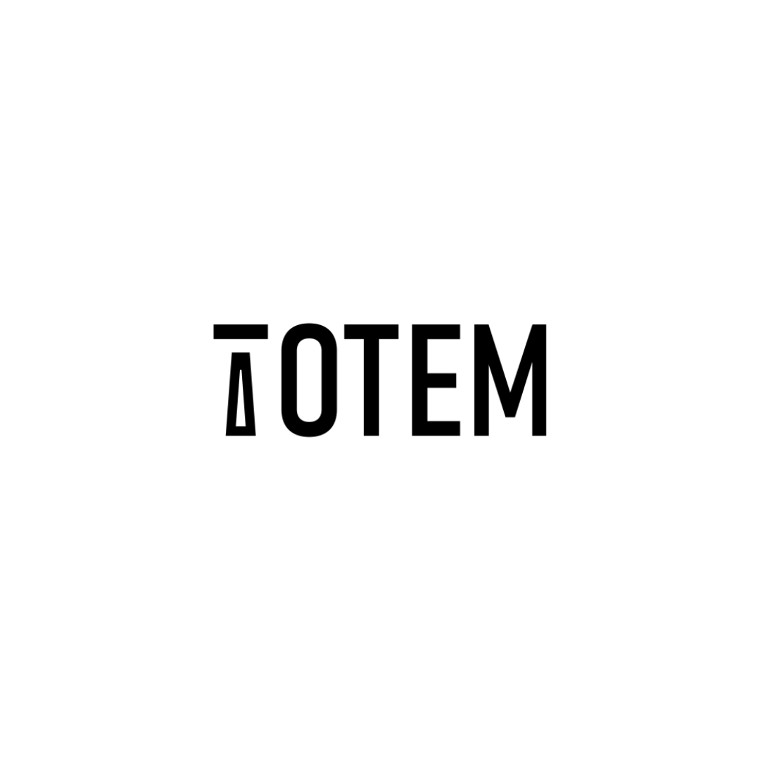 The image features a black rectangular background with the word 'ÁTOTEM' written in white, uppercase letters, centered on the rectangle.
