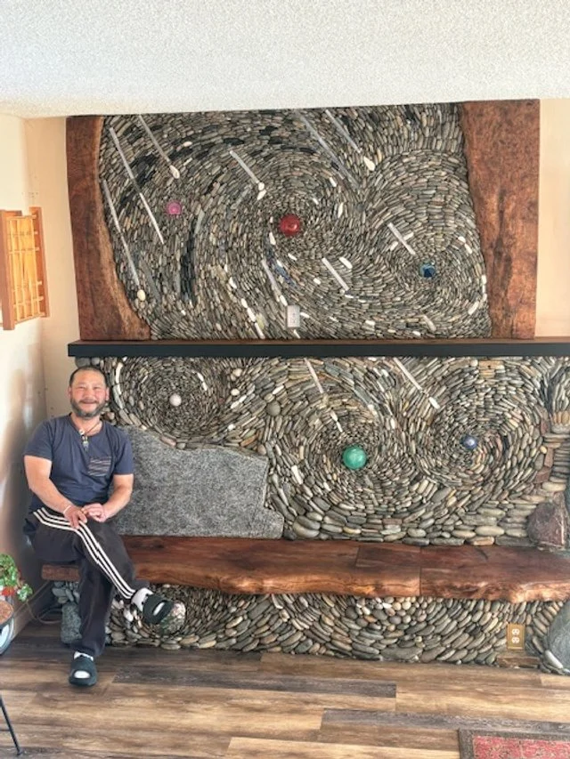 Worldly fireplace (with artist), January 2026, River rock, crystal, maple wood, 15'x10'