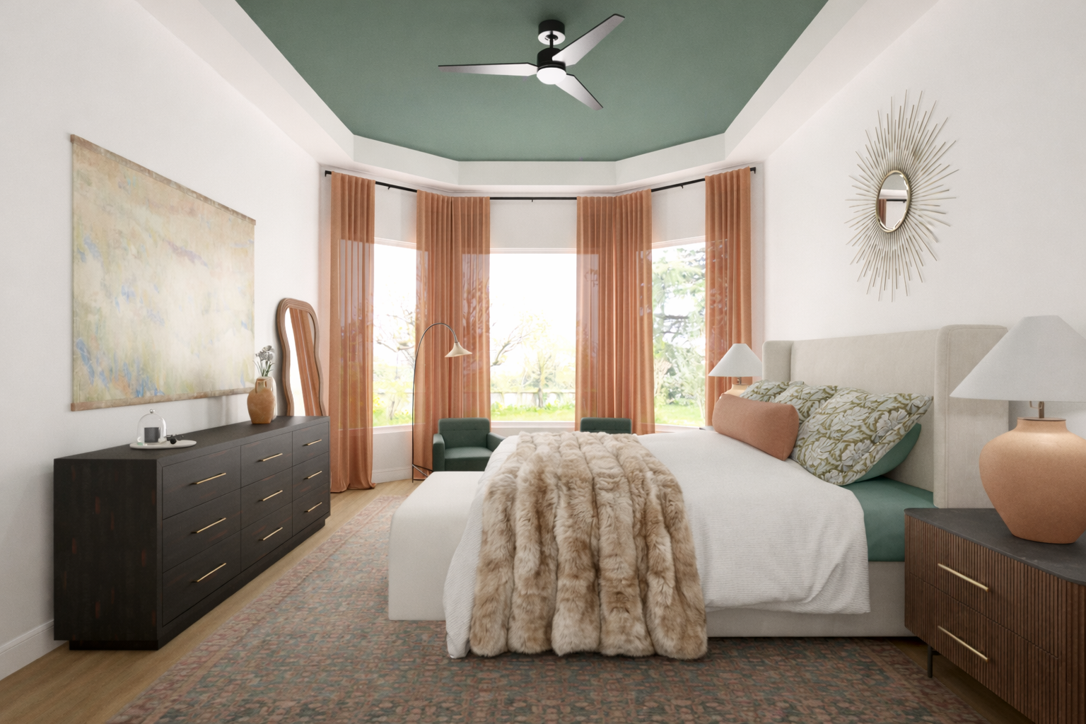 Bright bedroom with a large bed featuring patterned pillows, a fur blanket, light-colored upholstery, and two lamps on matching bedside tables. There are orange sheer curtains on large windows, a dark dresser with decorative items, a mirror with a st