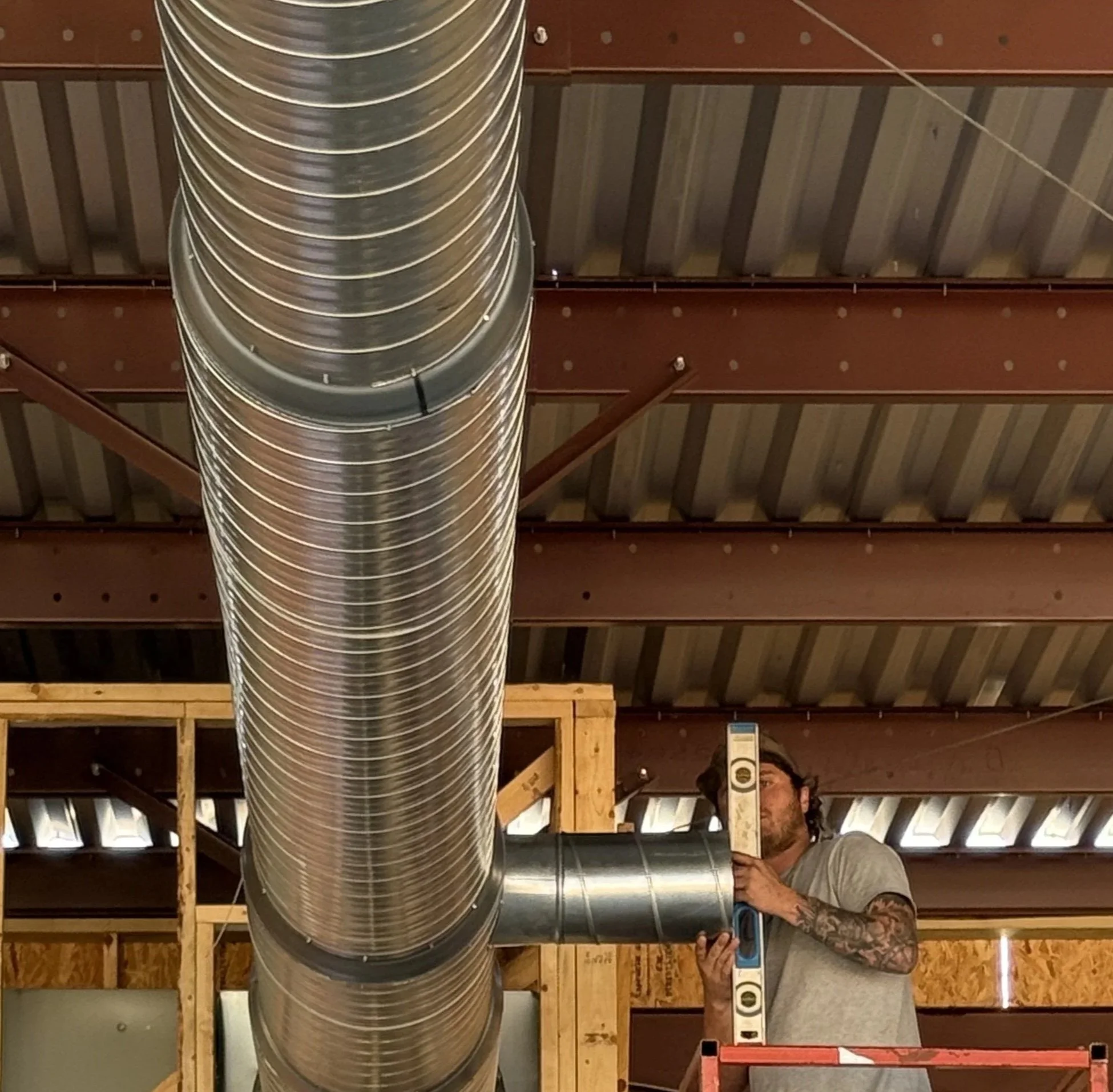 HVAC techniciain installing commercial ductwork.