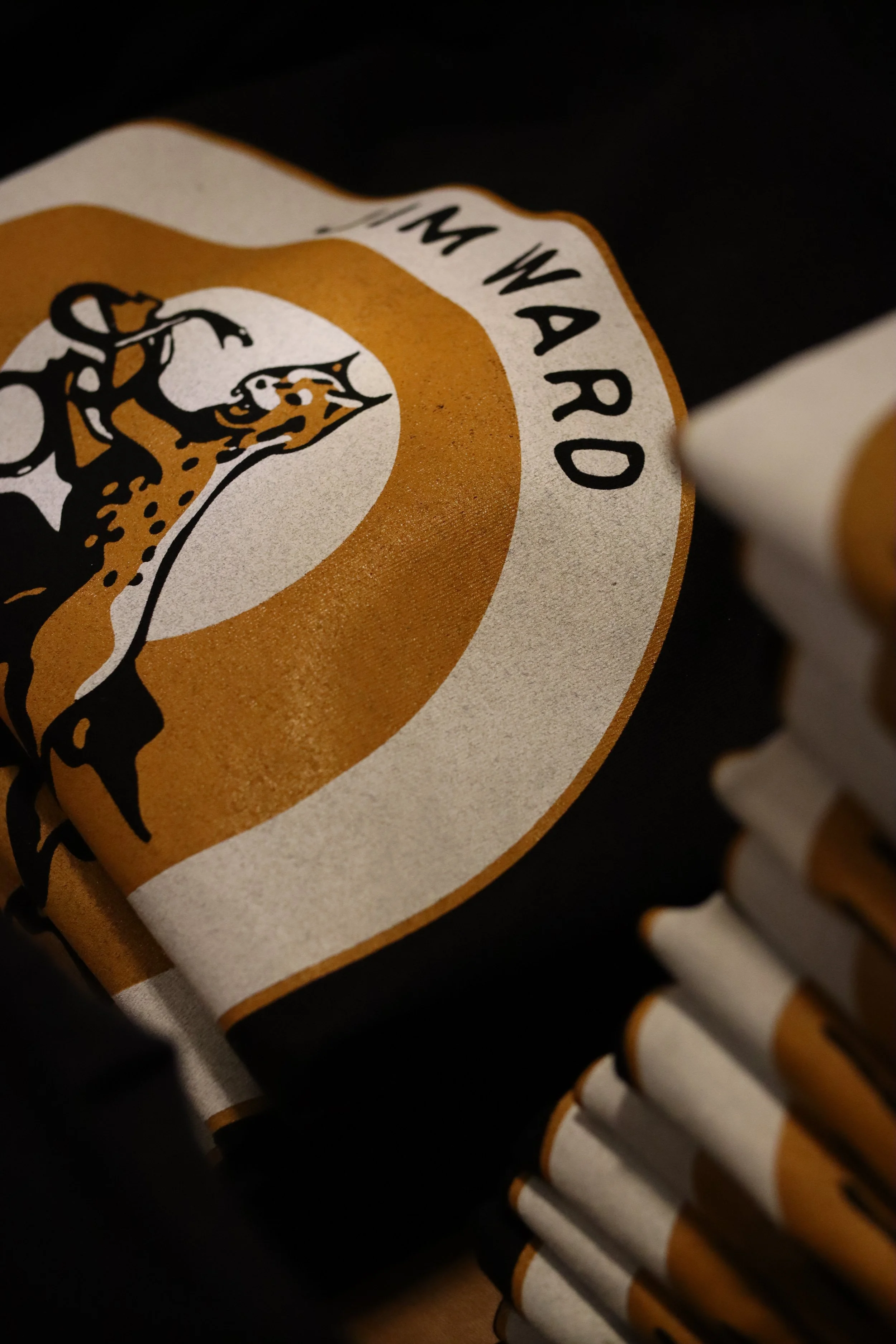 Custom screen-printed t-shirts featuring a leopard logo and bold text, designed by MOAB for fashion and promotional branding.